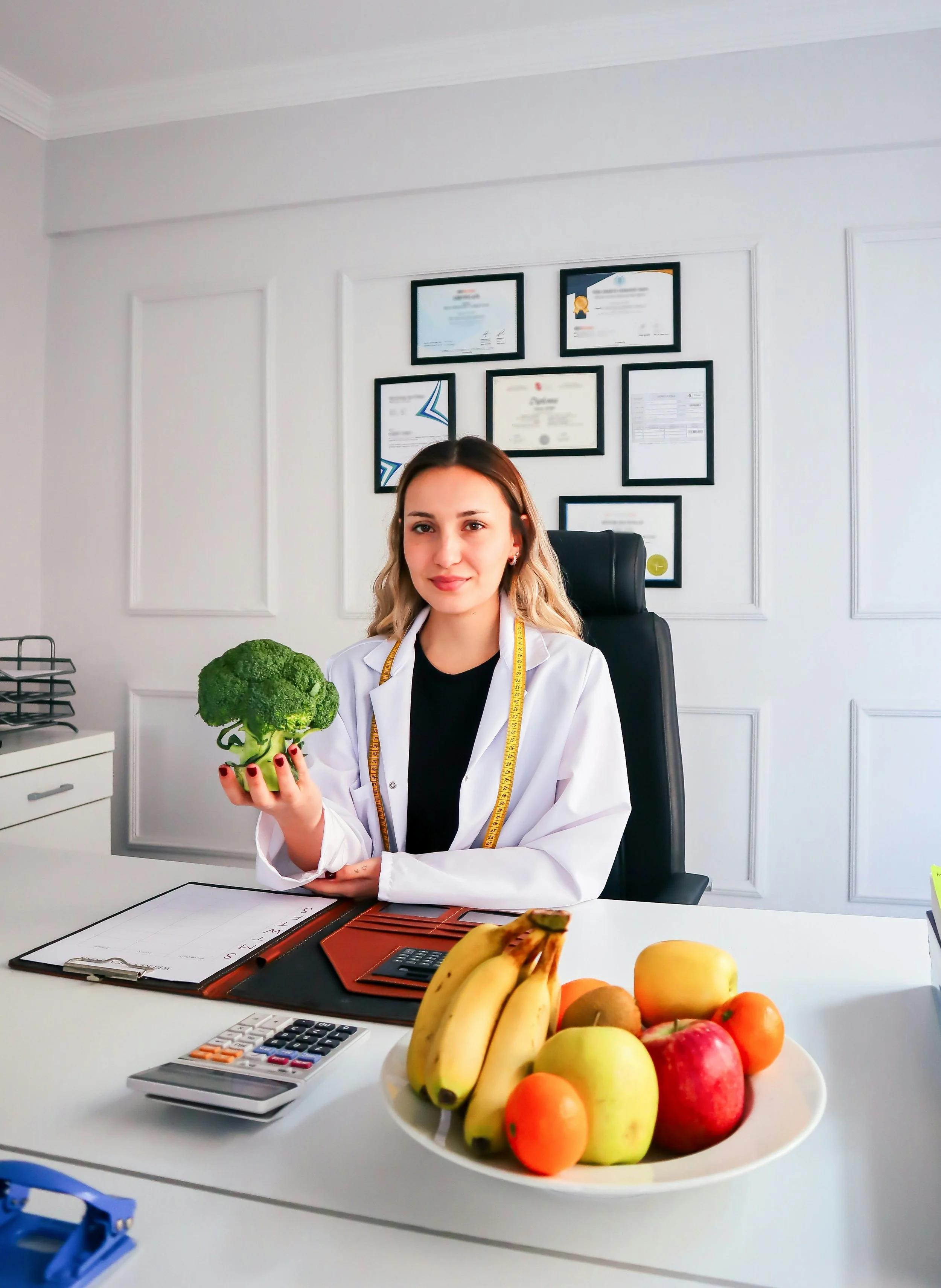 a dietitian holding a broccoli