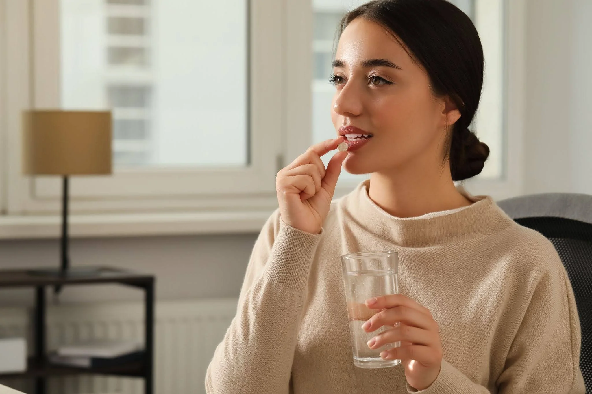 a young woman taking dietary supplements