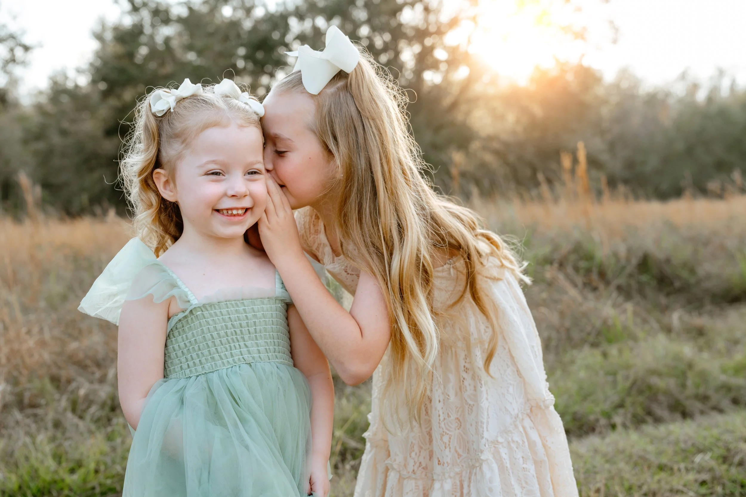 young sister giggle for professional photo in wesley chapel florida