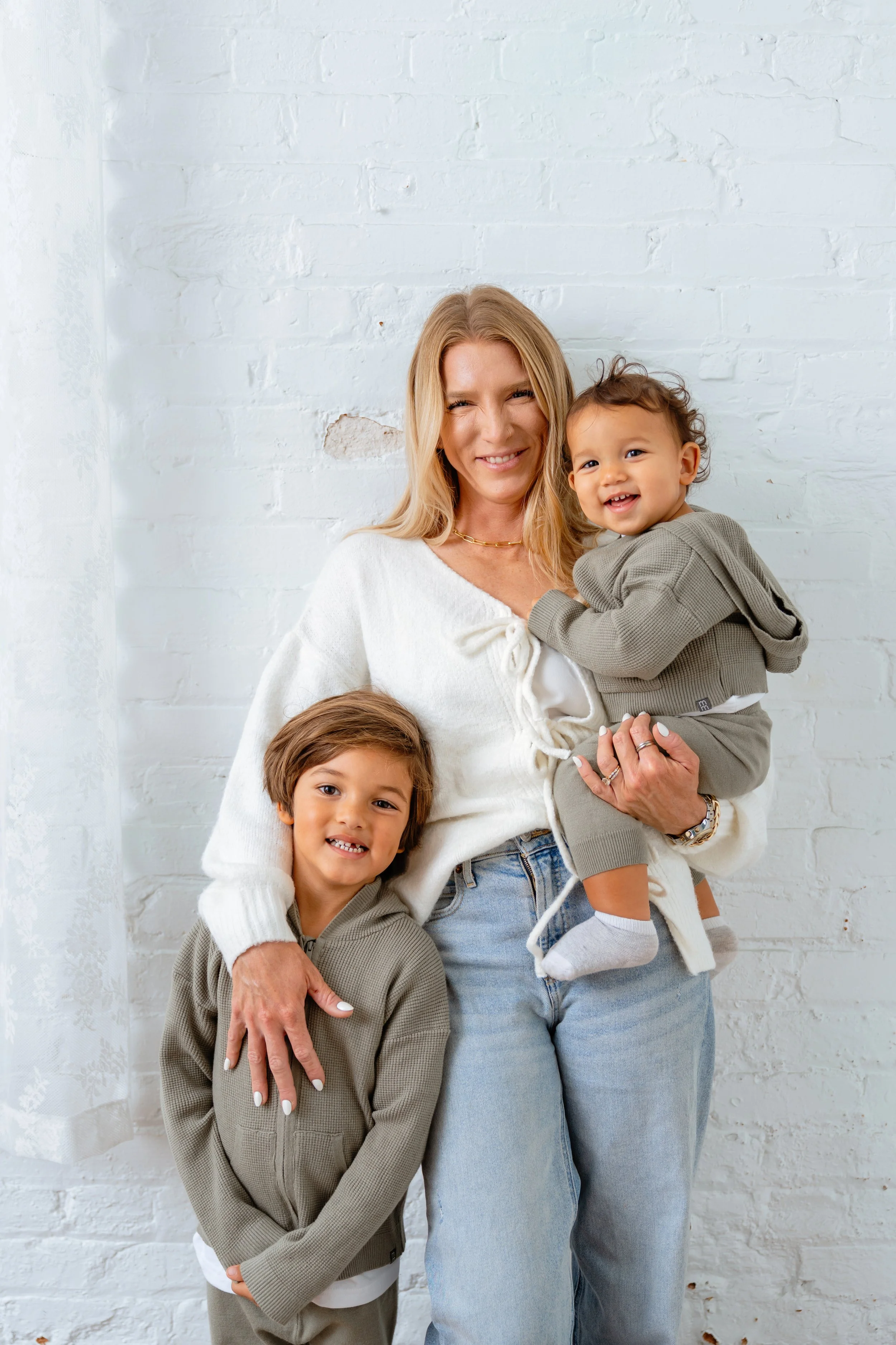 mom poses with young sons for professional family photos in Tampa