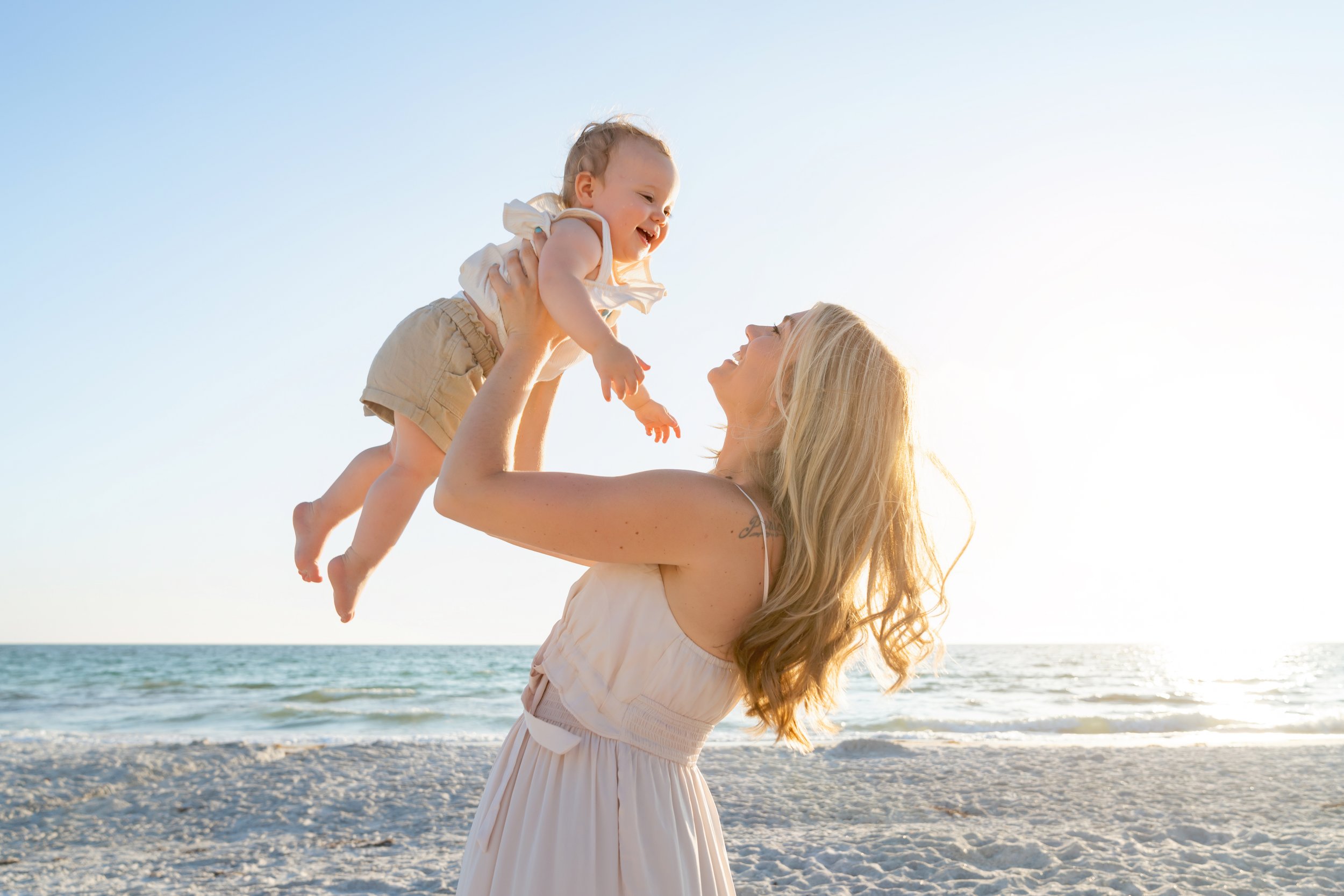  Mom and baby pose for family photos on the beach 