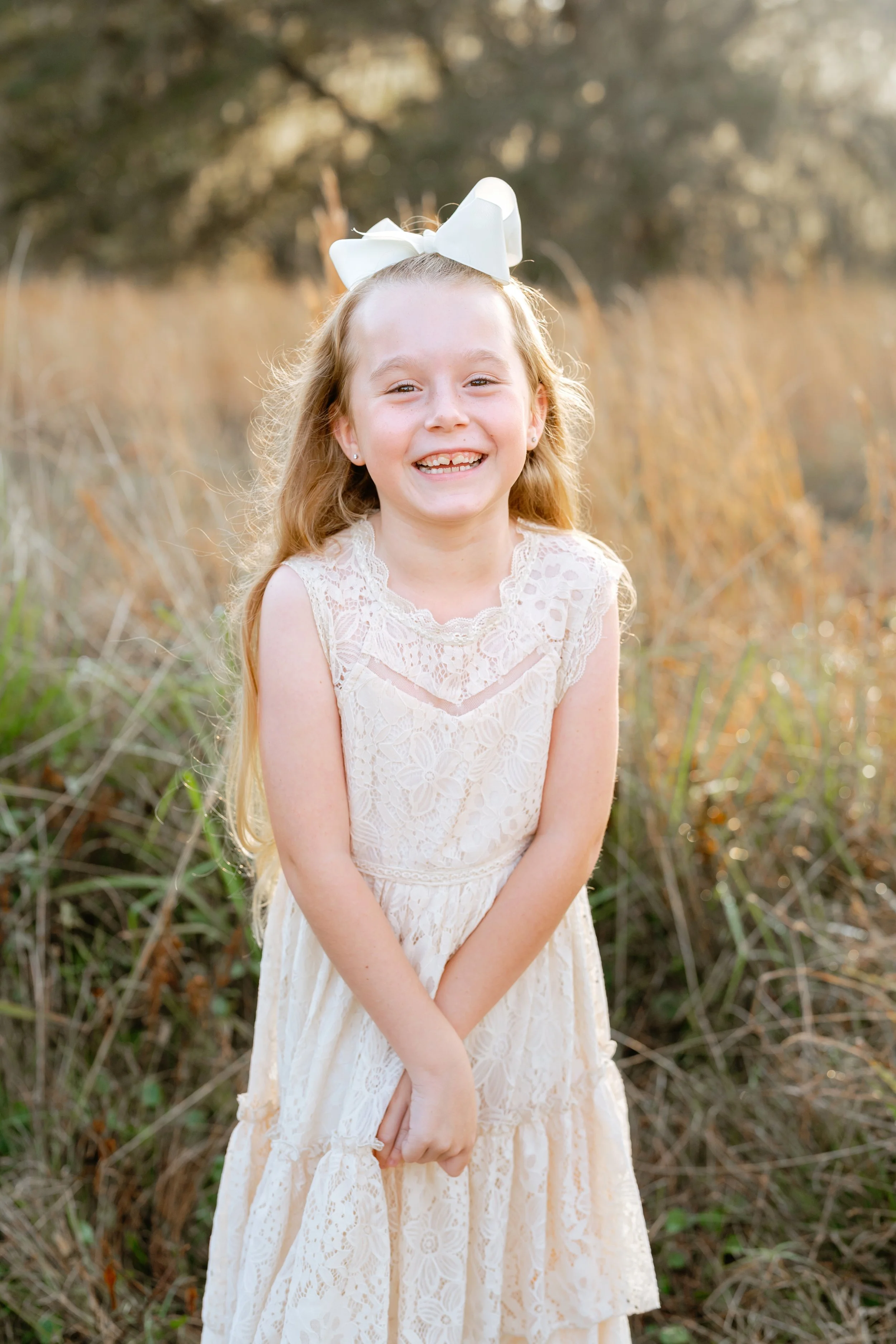 little girl poses for photo during professional family photography session in wesley chapel florida