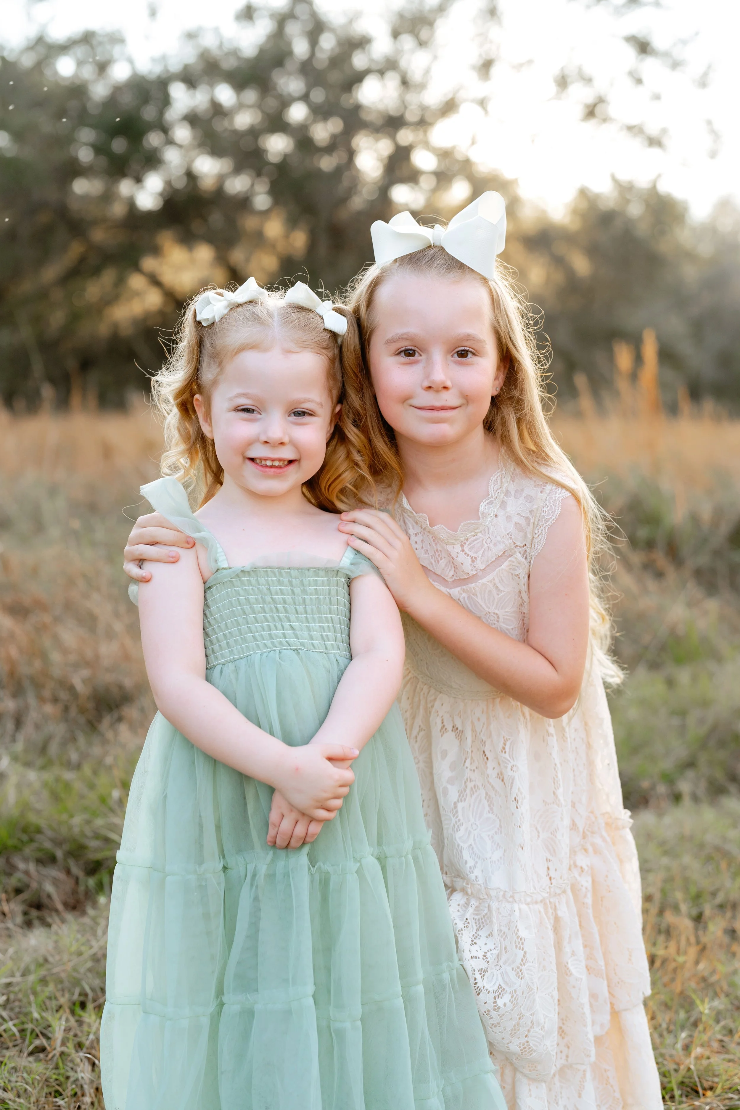 young sister pose for family photos at professional photography session in Wesley Chapel florida