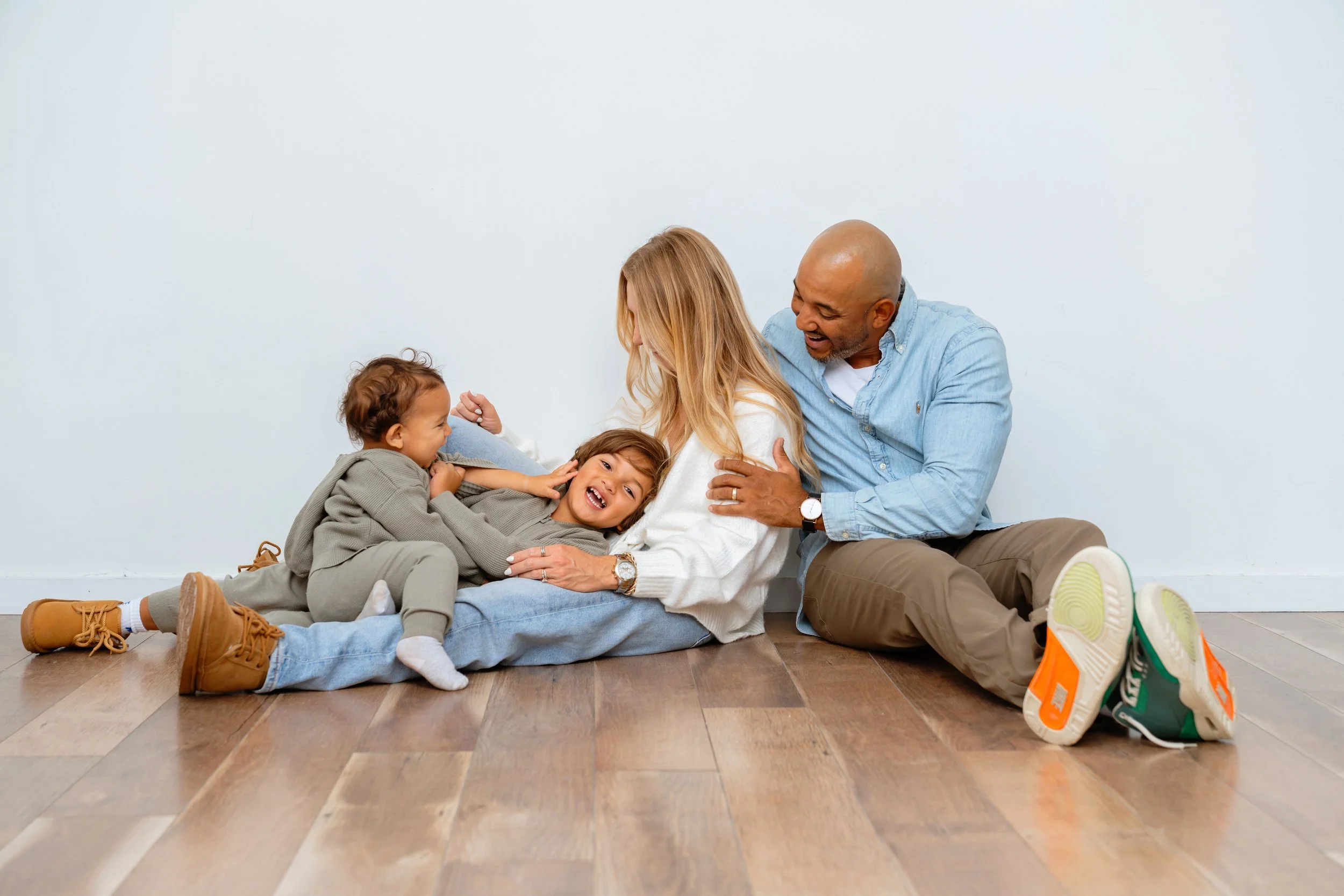 professional family portrait of a young family playing on the floor at tampa photography studio
