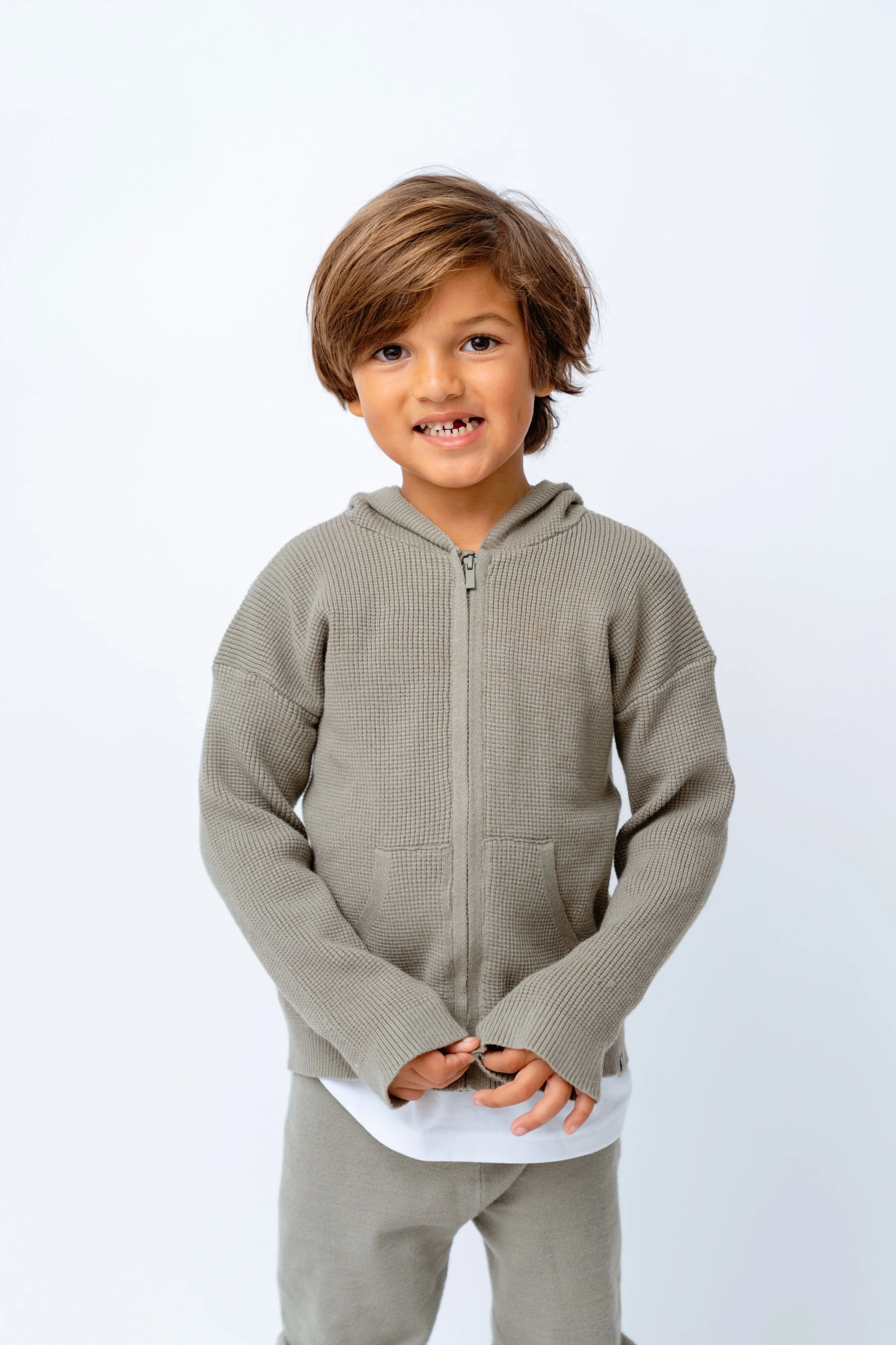 little boy poses for professional portrait at tampa studio