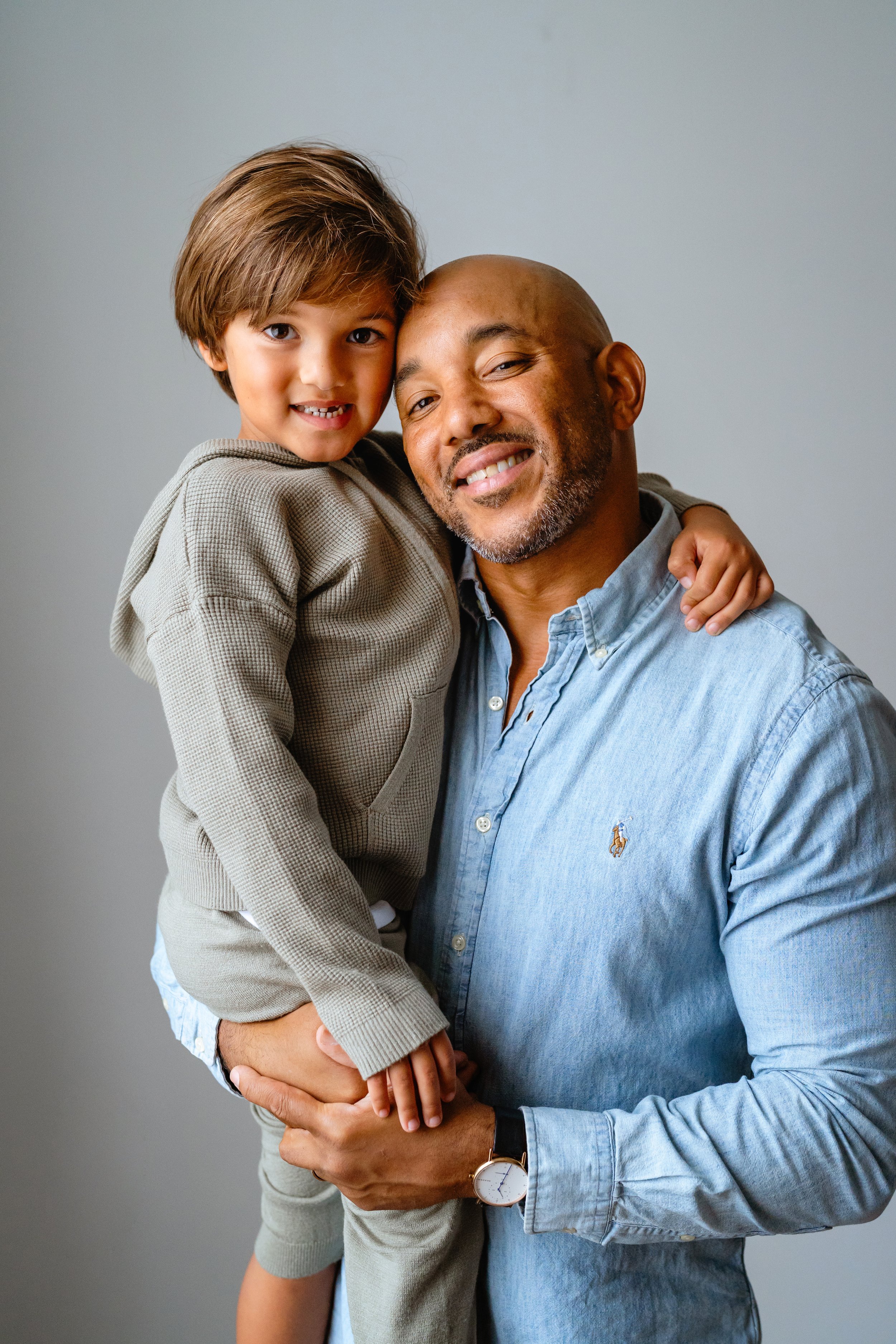 dad poses with young son for professional family photos in tampa florida