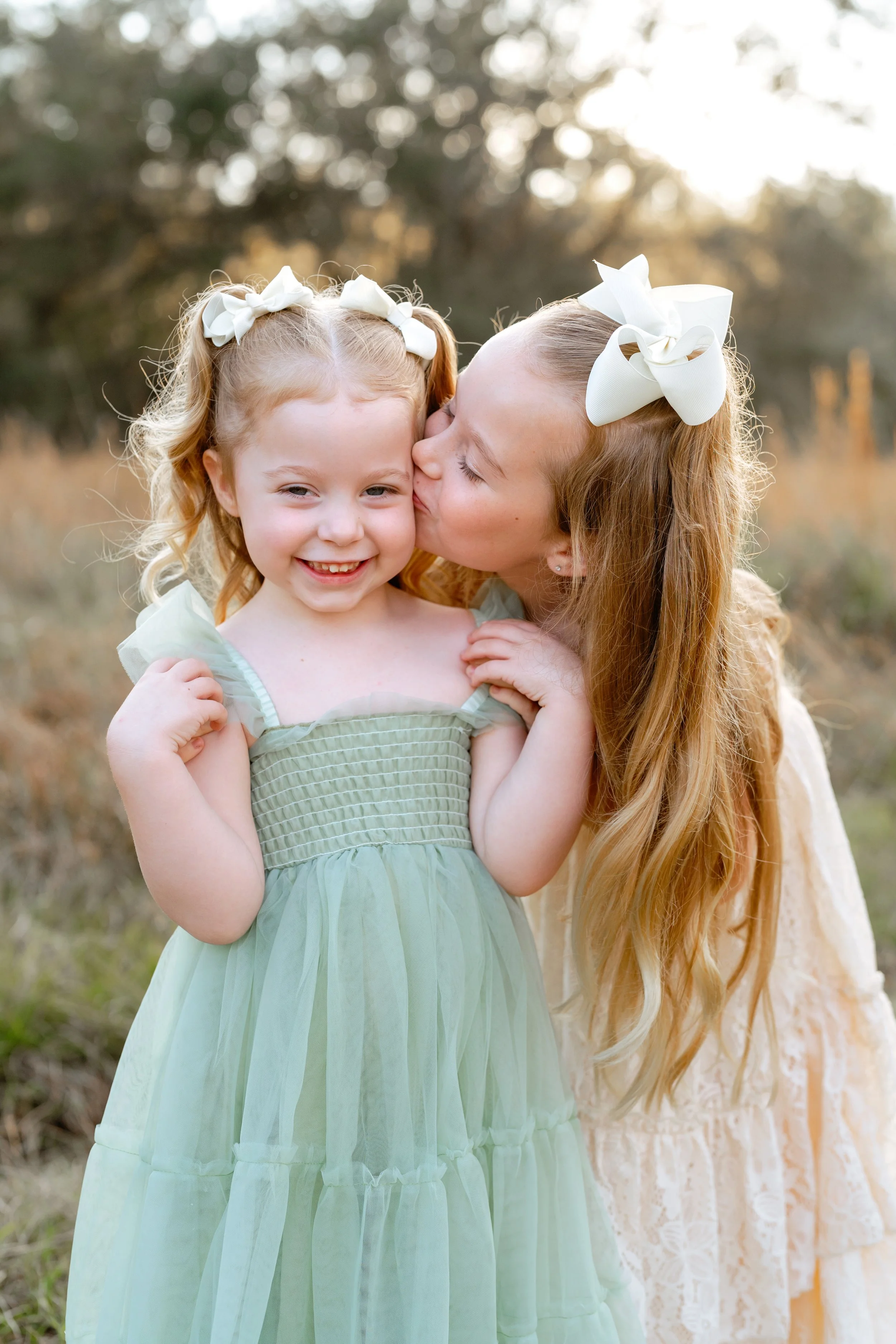 young sister pose for family photos at professional photography session in Wesley Chapel florida