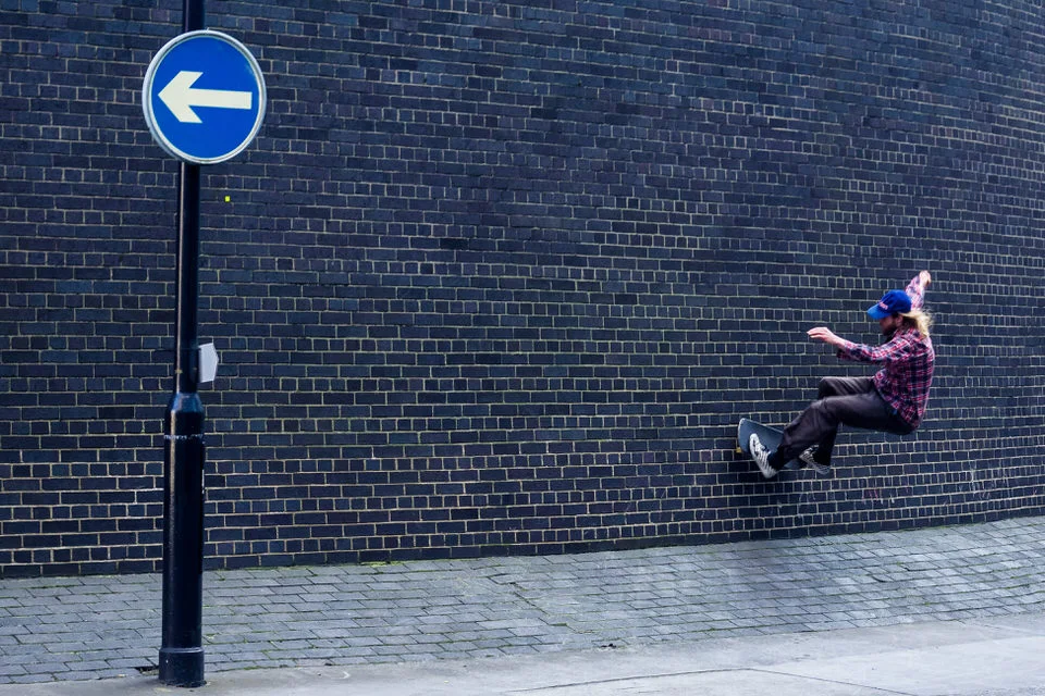 Skateboarder wall ride