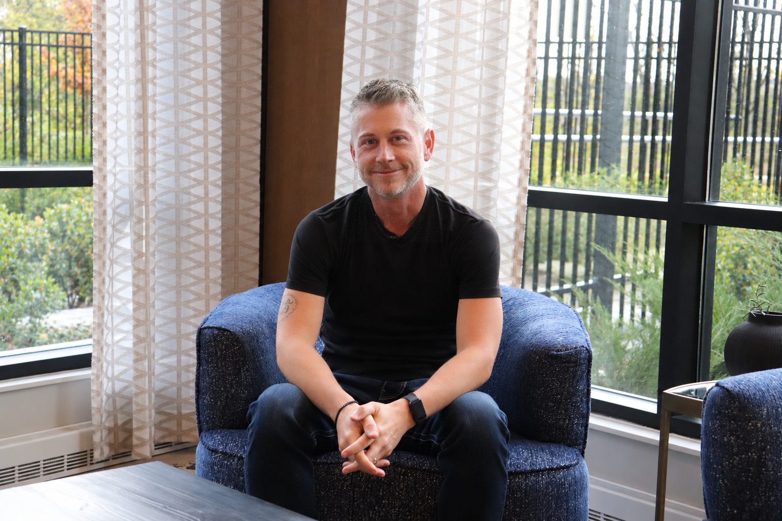 Paul sitting in a blue chair