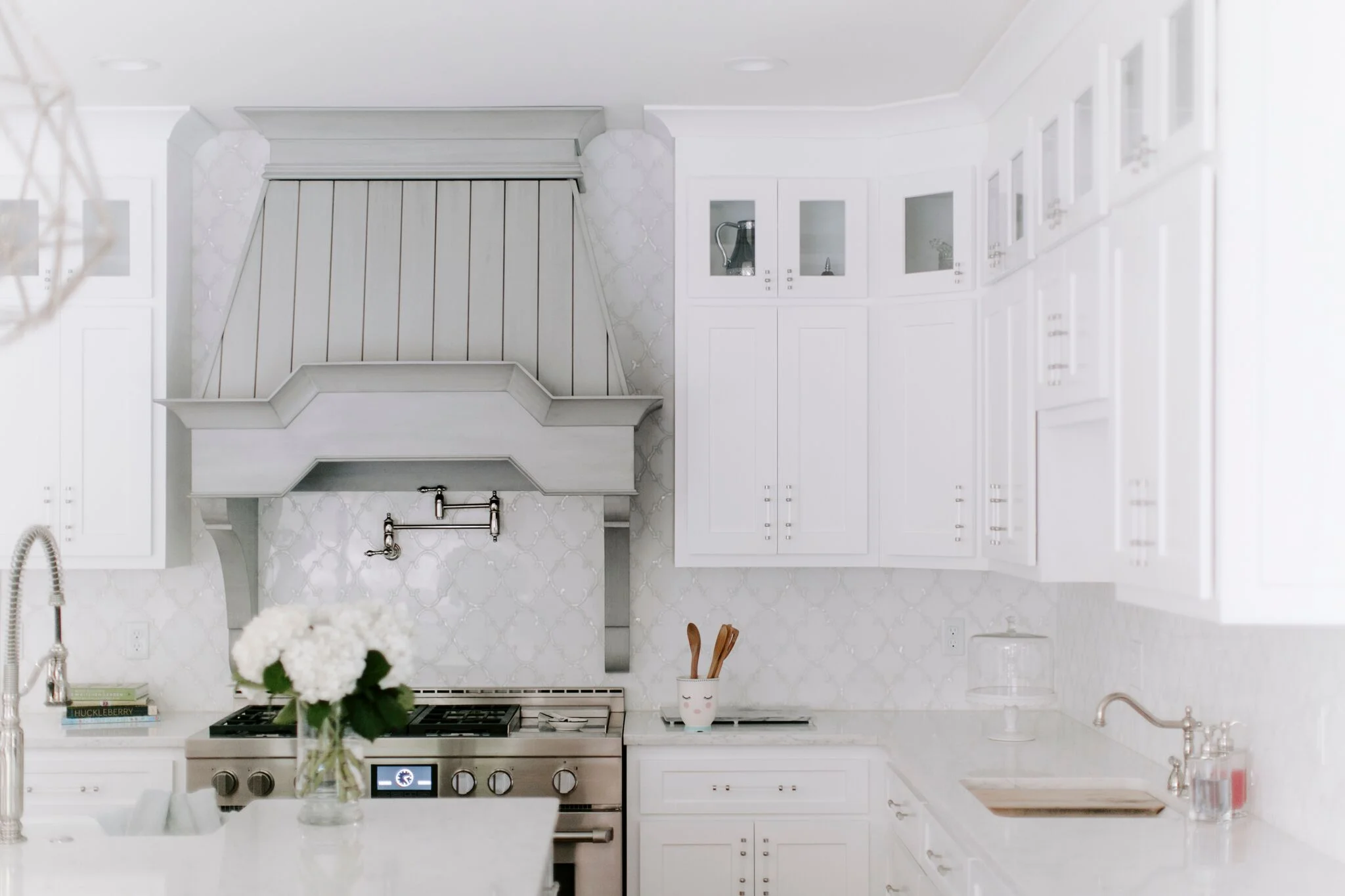 Glass upper cabinets fitted with dimmable lighting add an airiness to the space.
