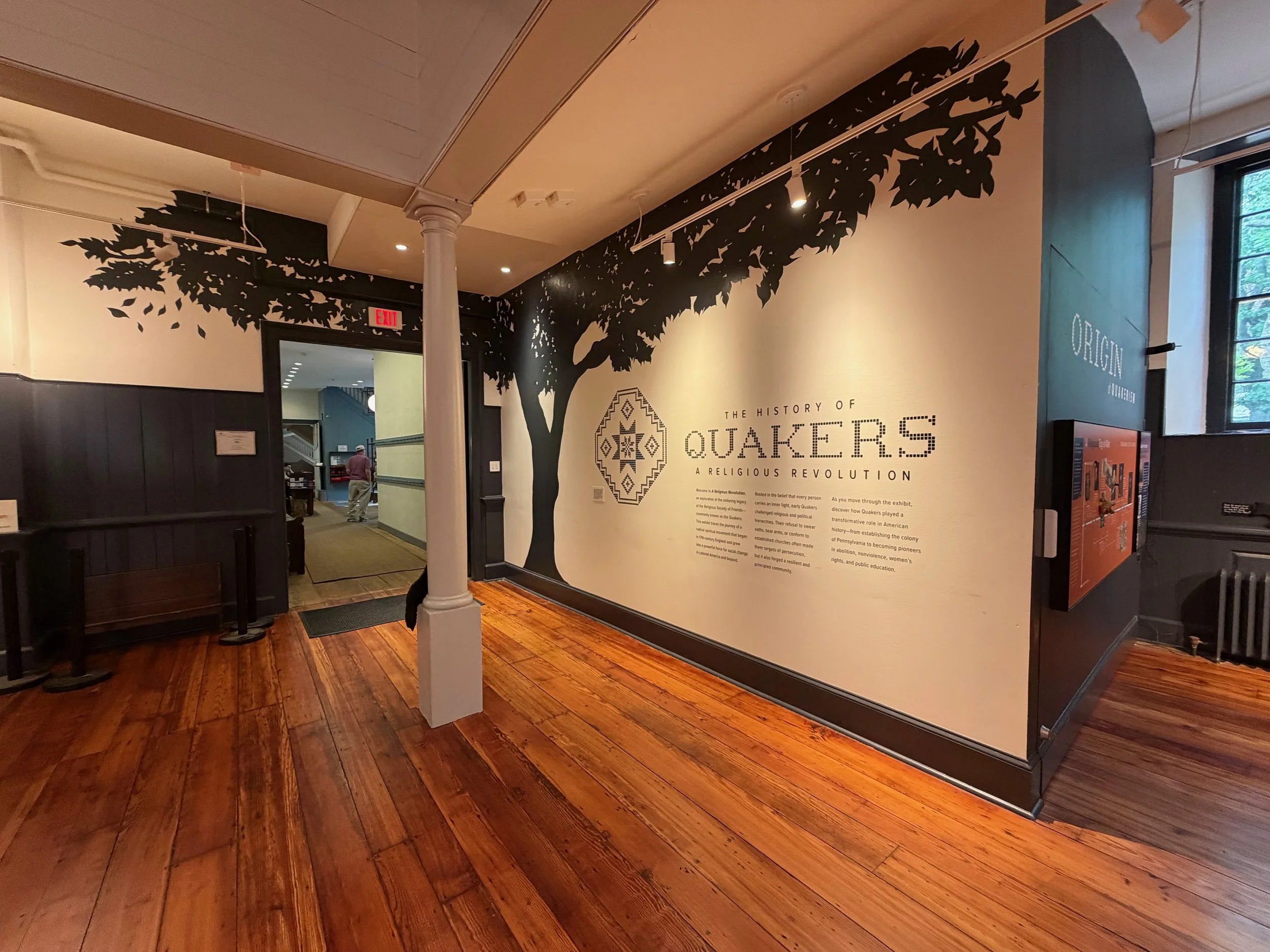  Exhibition introduction wall featuring a hand-painted elm tree silhouette. 