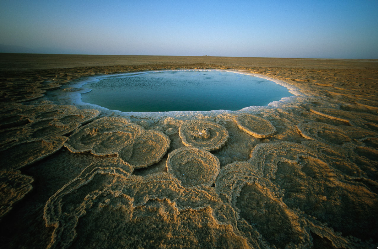 Wake up early in the morning to watch the sunrise over the discs of travertine—large, naturally formed calcite deposits in Ethiopia’s Danakil Depression, one of the hottest places on Earth. Photograph by Carsten Peter, Nat Geo Image Collection