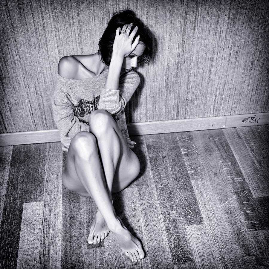 Sadness: Her sight far from us, looking for something, like her lost hope among the wooden plates of the floor.