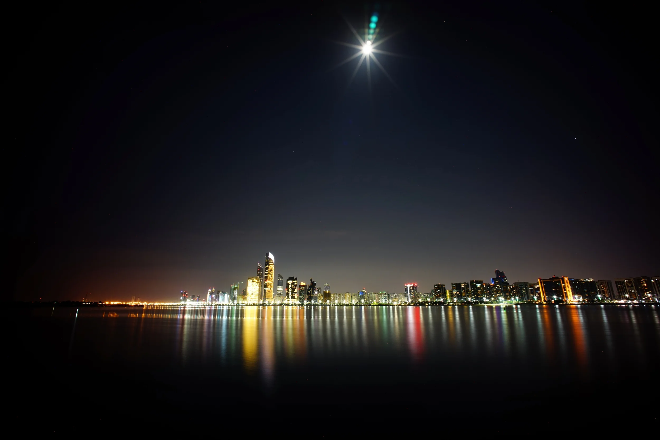 Abu Dhabi Skyline, I like how the moon seems to be like a lamp :) and yes, those are the reflections of the sensor on top of the moon