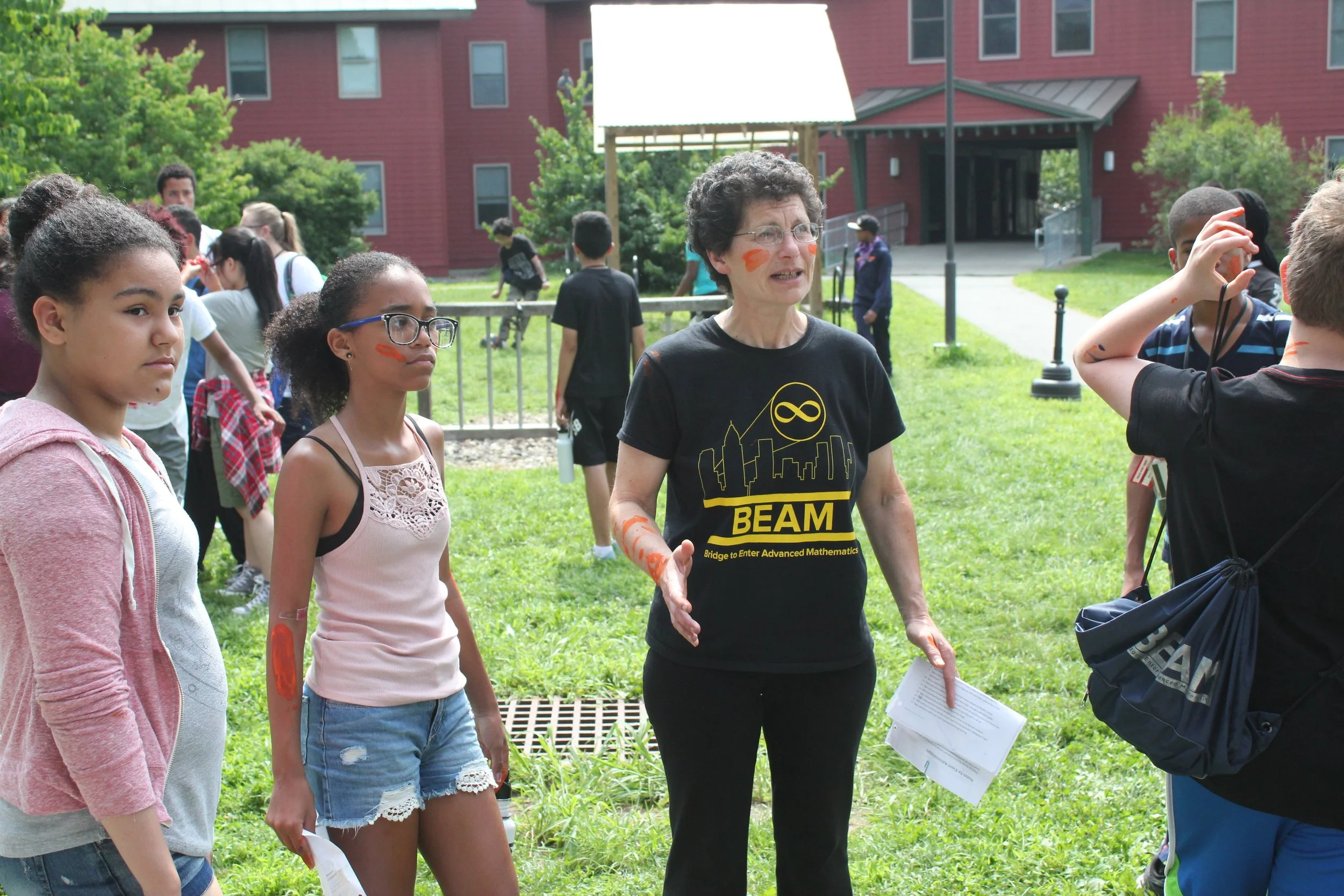 Instructor Tanya gathers the attention of members of the Orange Team as everybody prepares for Field Day activities.