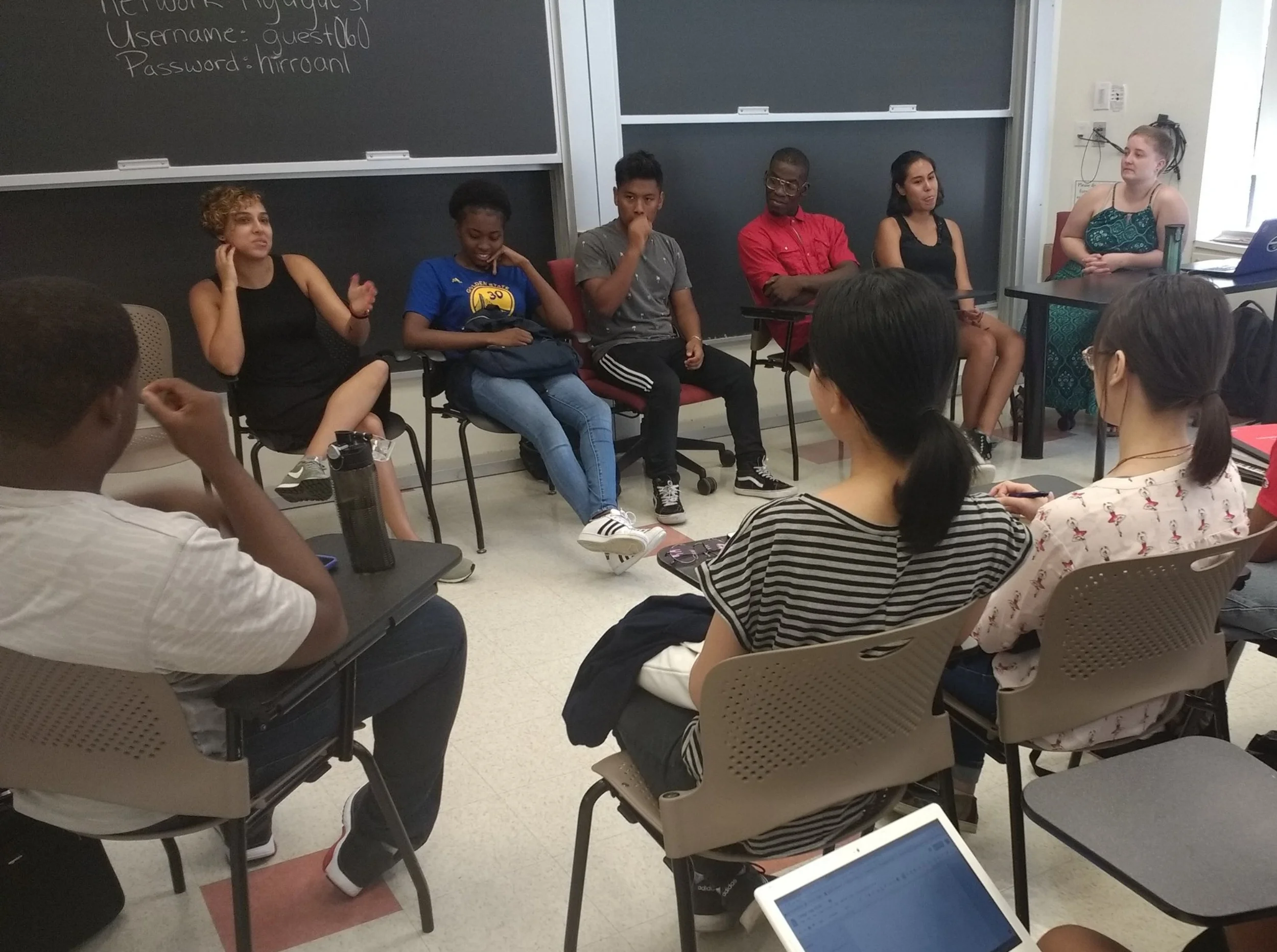 Aisha, front, second from left, sits on a panel of BEAM staff and alums providing college application advice to rising 11th and 12th graders, August 2018. 
