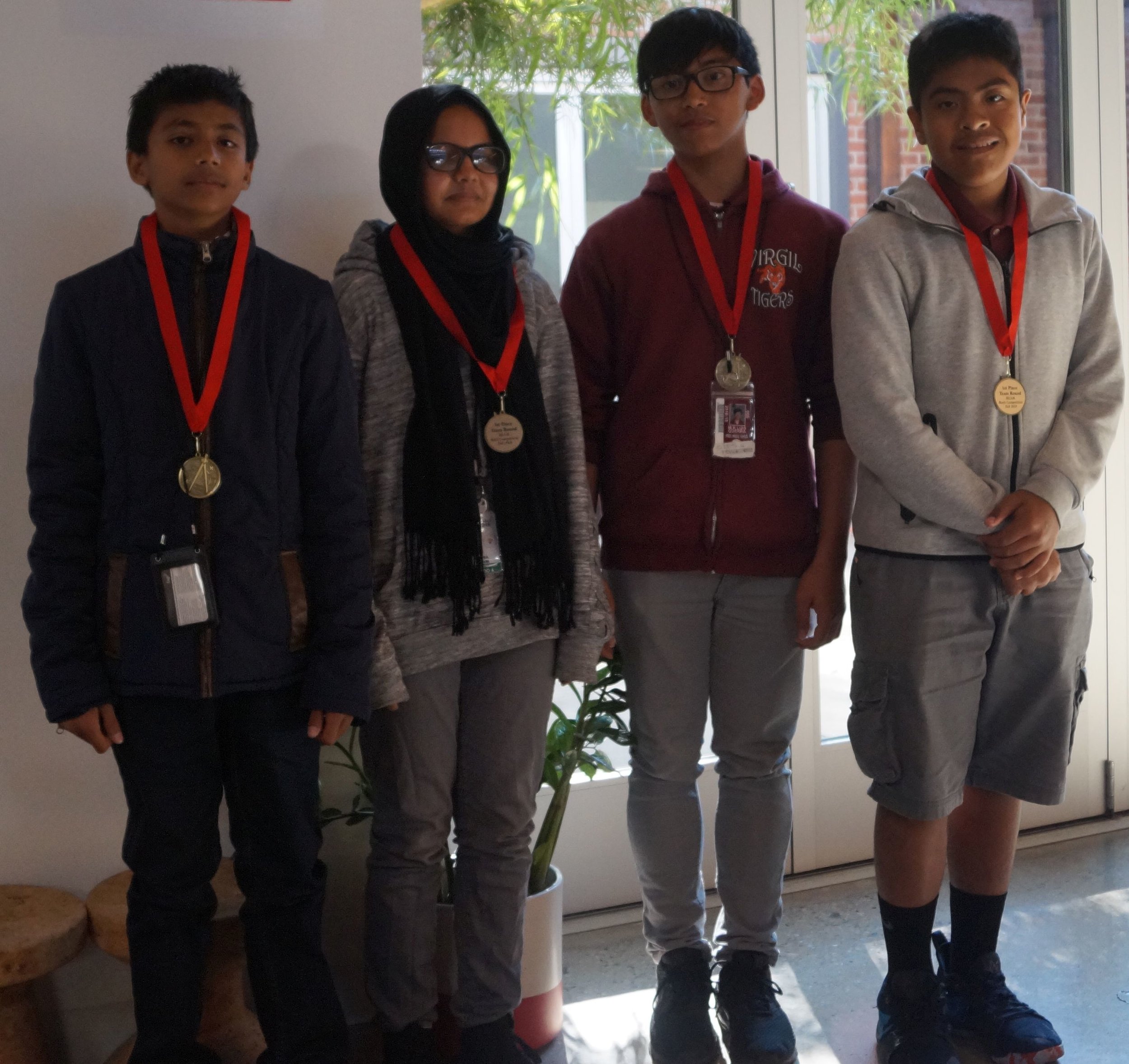  From left to right, Adib, Mayisa, M.K. Luis, and Kevin won first place in the team round representing Virgil Middle School. 