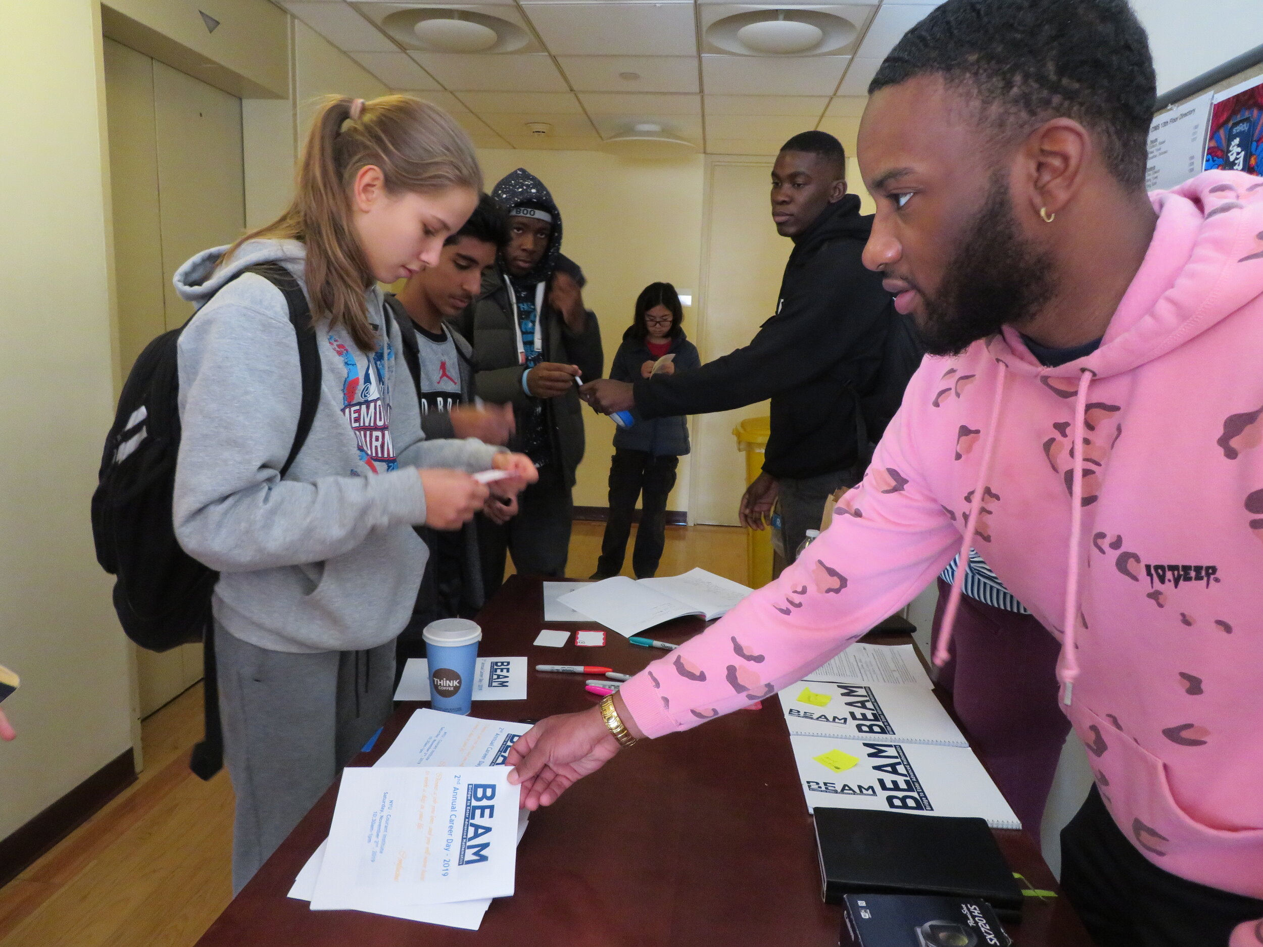  BEAM alumni John and Quentin (Fordham University junior and Ithaca College graduate, respt.) check BEAM high school students in as they arrive to Career Day. 