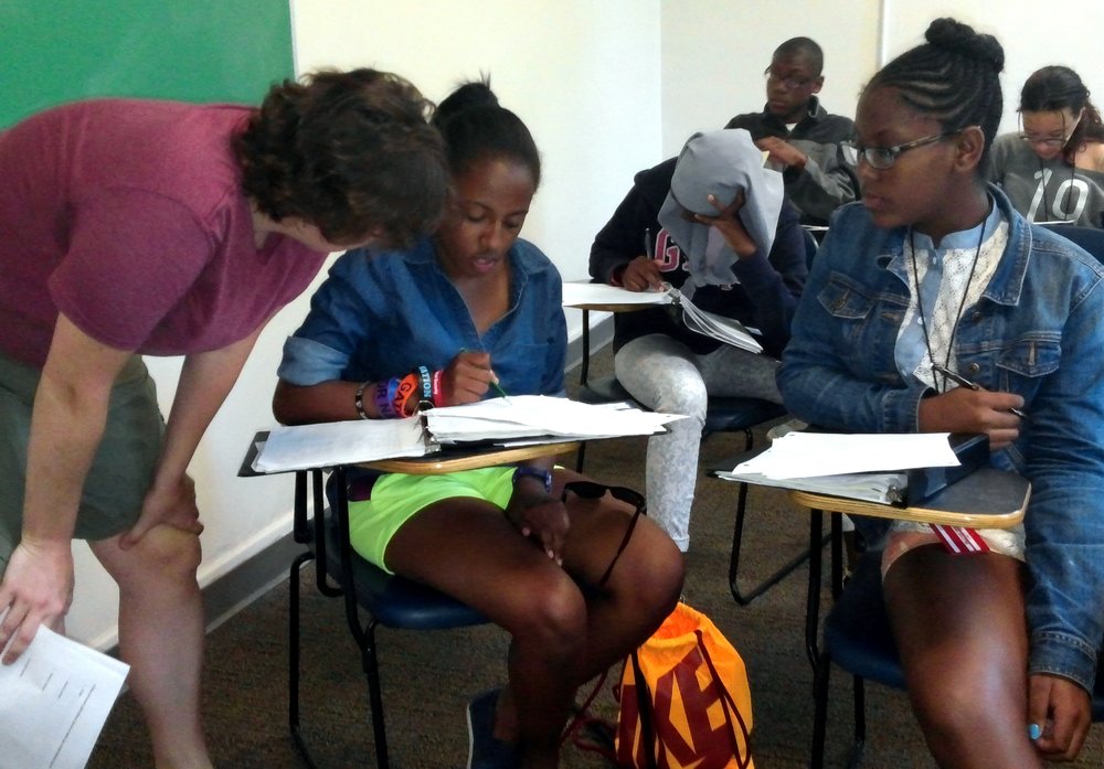  At Summer Away, Zeñia took classes in combinatorics, problem solving, proofs, and Hamming codes. In the photo, she receives support from a faculty member. 