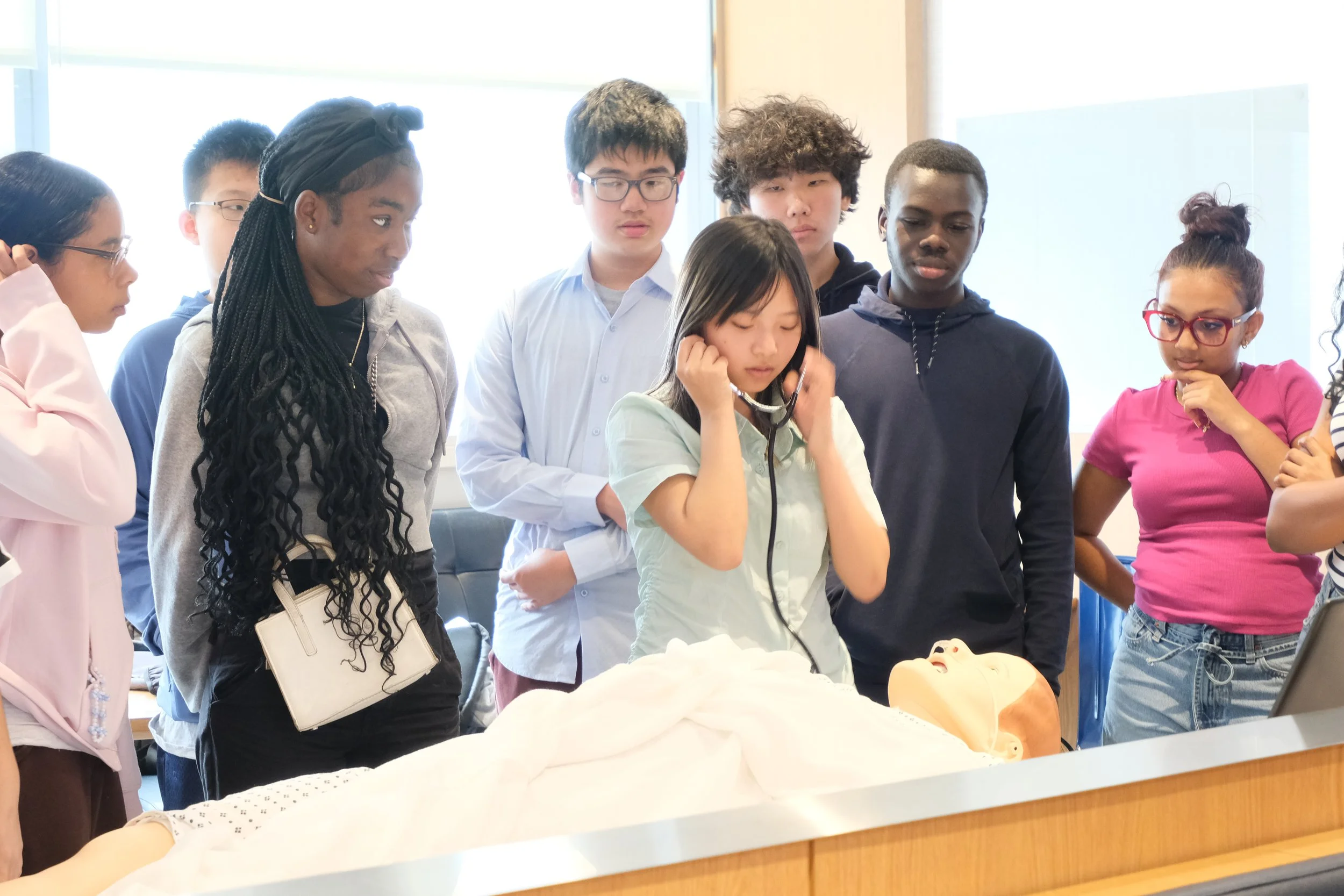  NYC students examine a medical dummy at the Memorial Sloane Kettering Cancer Research Center.  