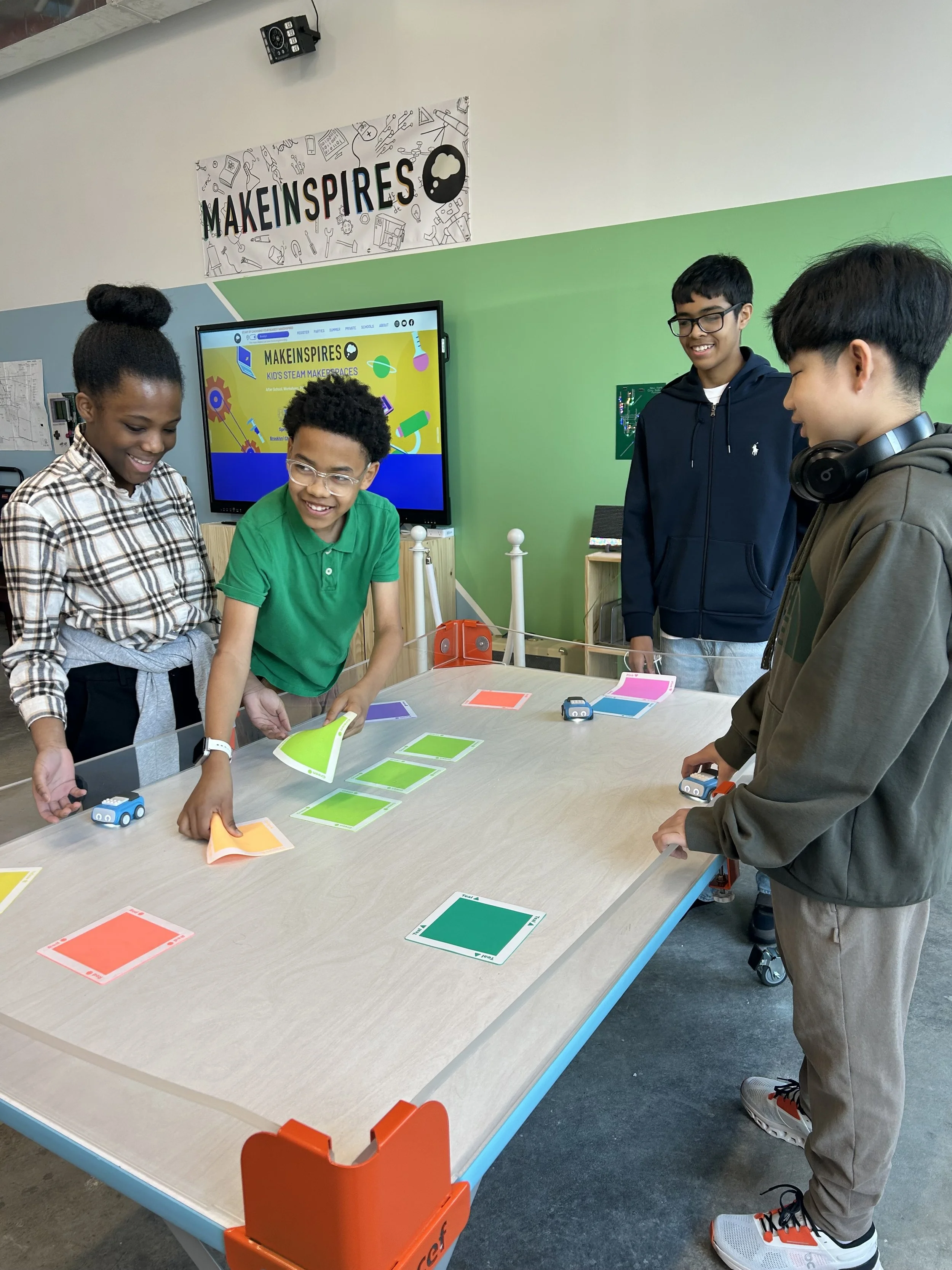  8th-graders in NYC code robot cars during a visit to the MakeInspires STEM makerspace.  