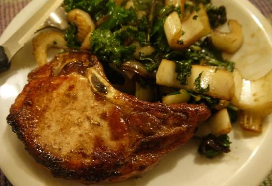 Pan-seared pork chop with sauteed greens