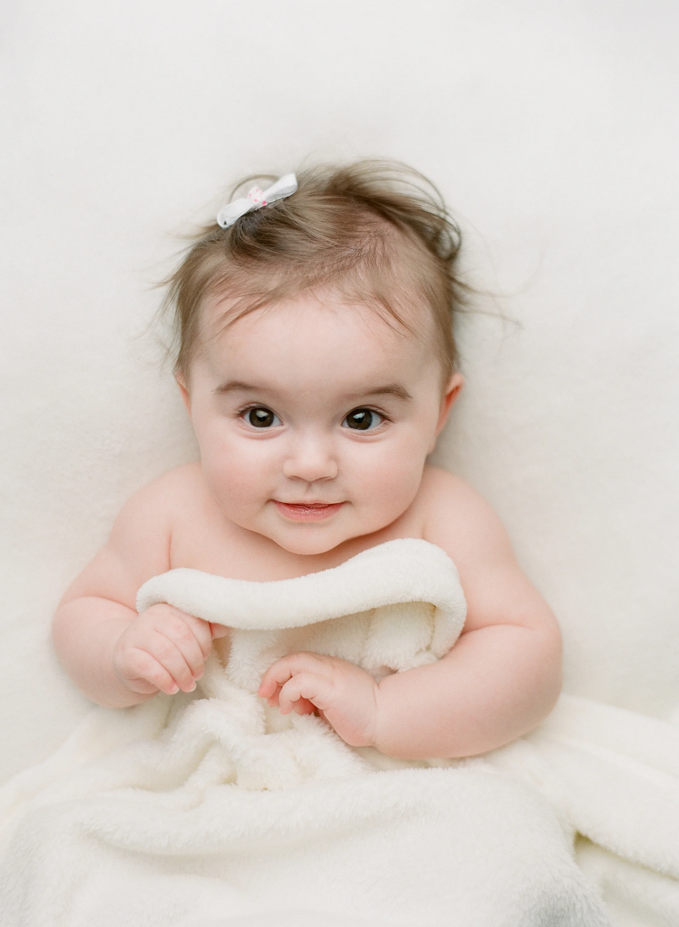 Baby photography Seattle, by Sandra Coan. Studio photograph. Baby looking up into the camera
