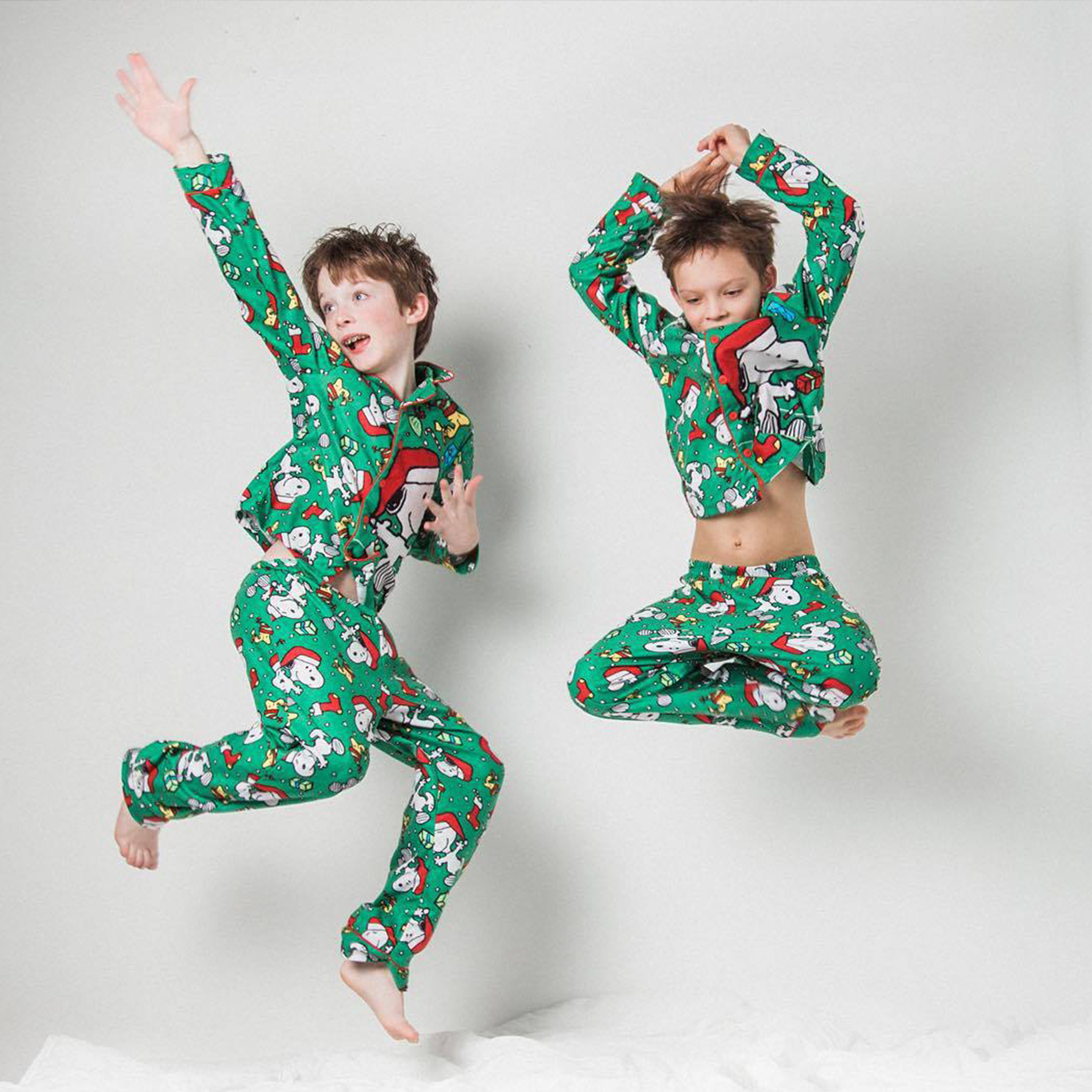 Brothers jumping in matching holiday outfits in Seattle mini sessions