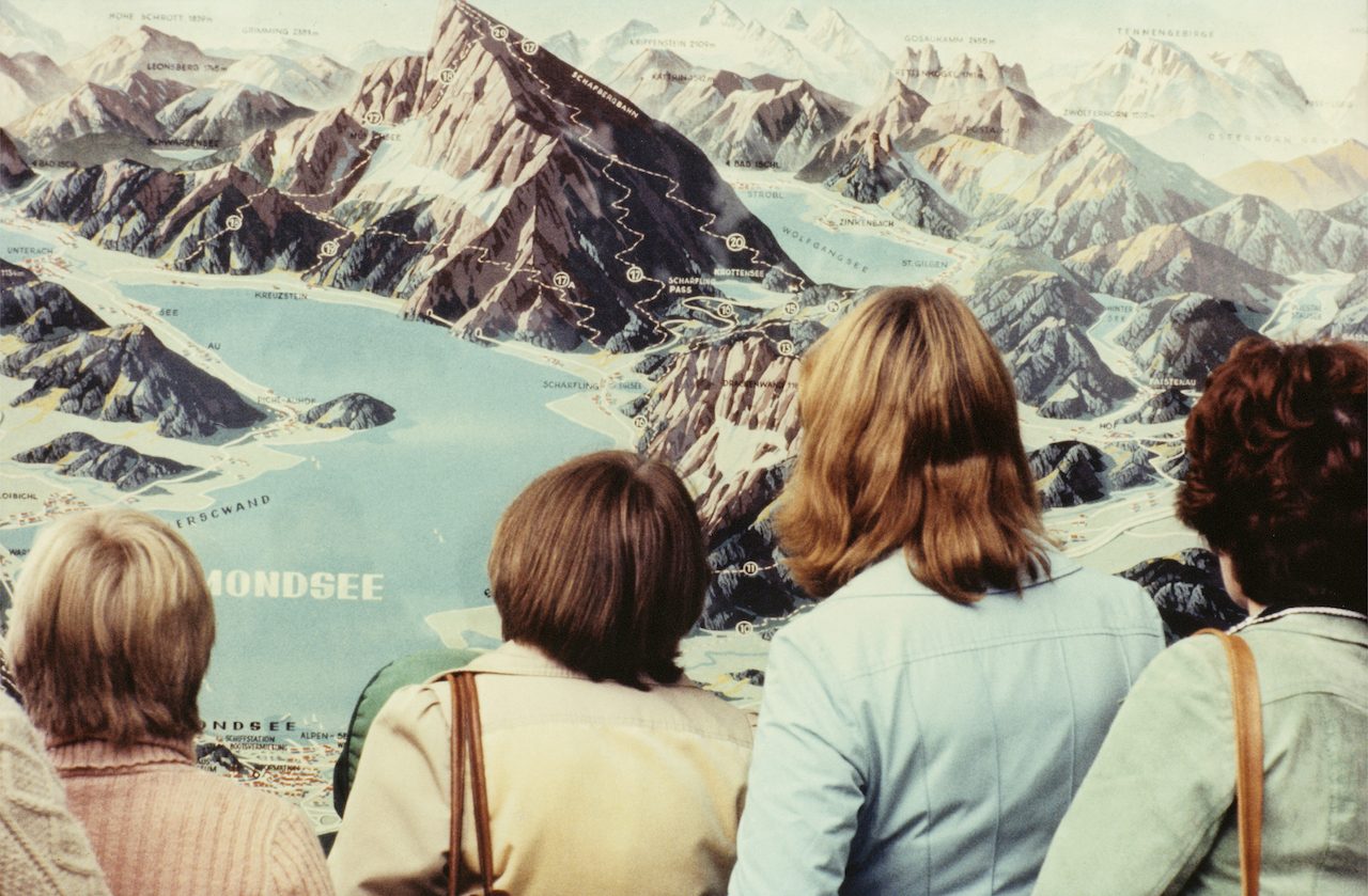  Luigi Ghirri  Four women looking at the maps of the Alps, 1977 Image: © Eredi Luigi Ghirri 