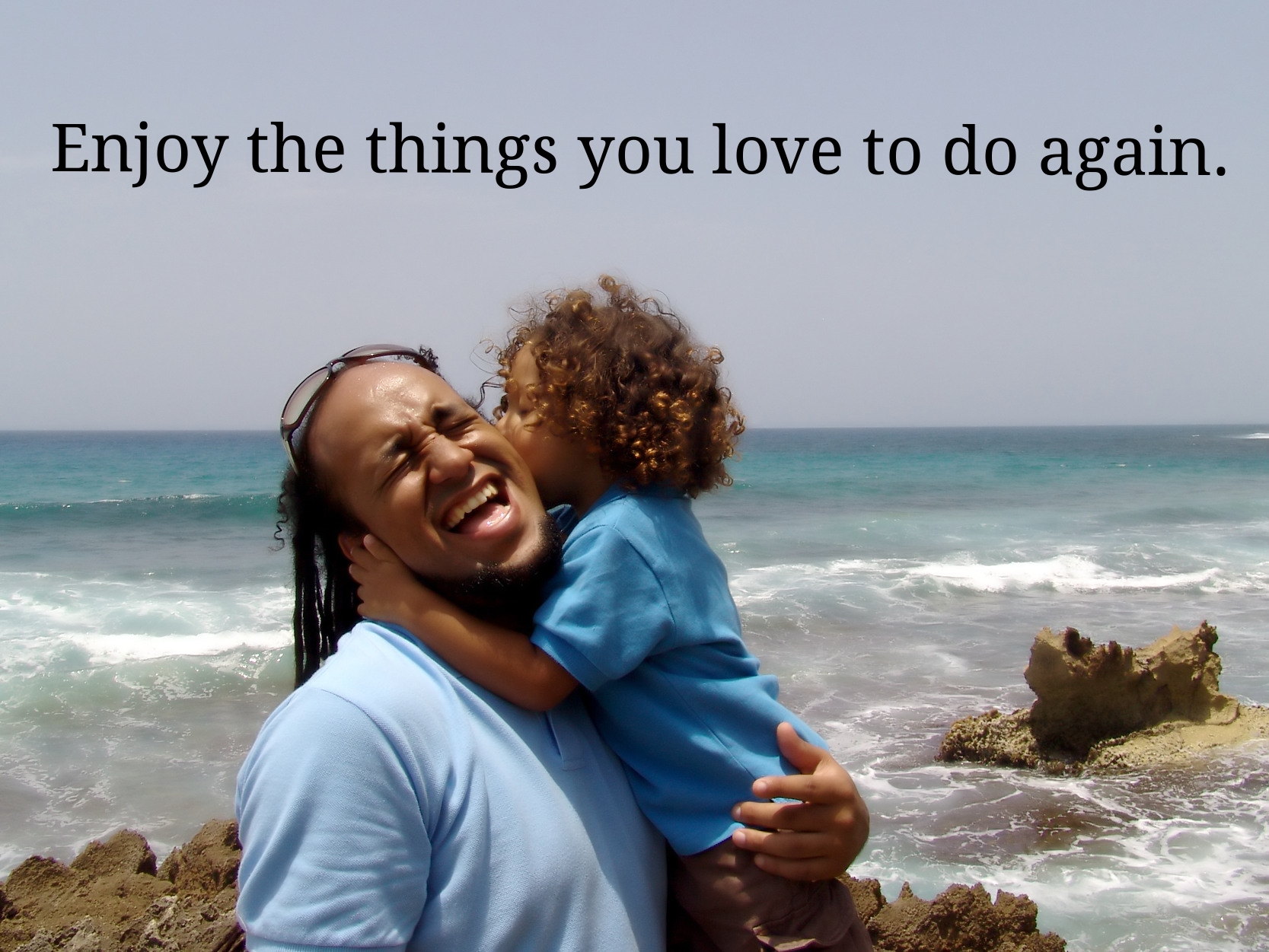 Enjoy the things you love to do again (A dad holds his son on the beach).