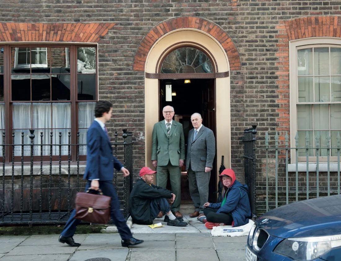Early morning. The Artists set out for breakfast at Jeff's Cafe in nearby Brune Street. Seated are the Artist's friends George Crompton and Tara McKerr. Image courtesy Gilbert & George / White Cube