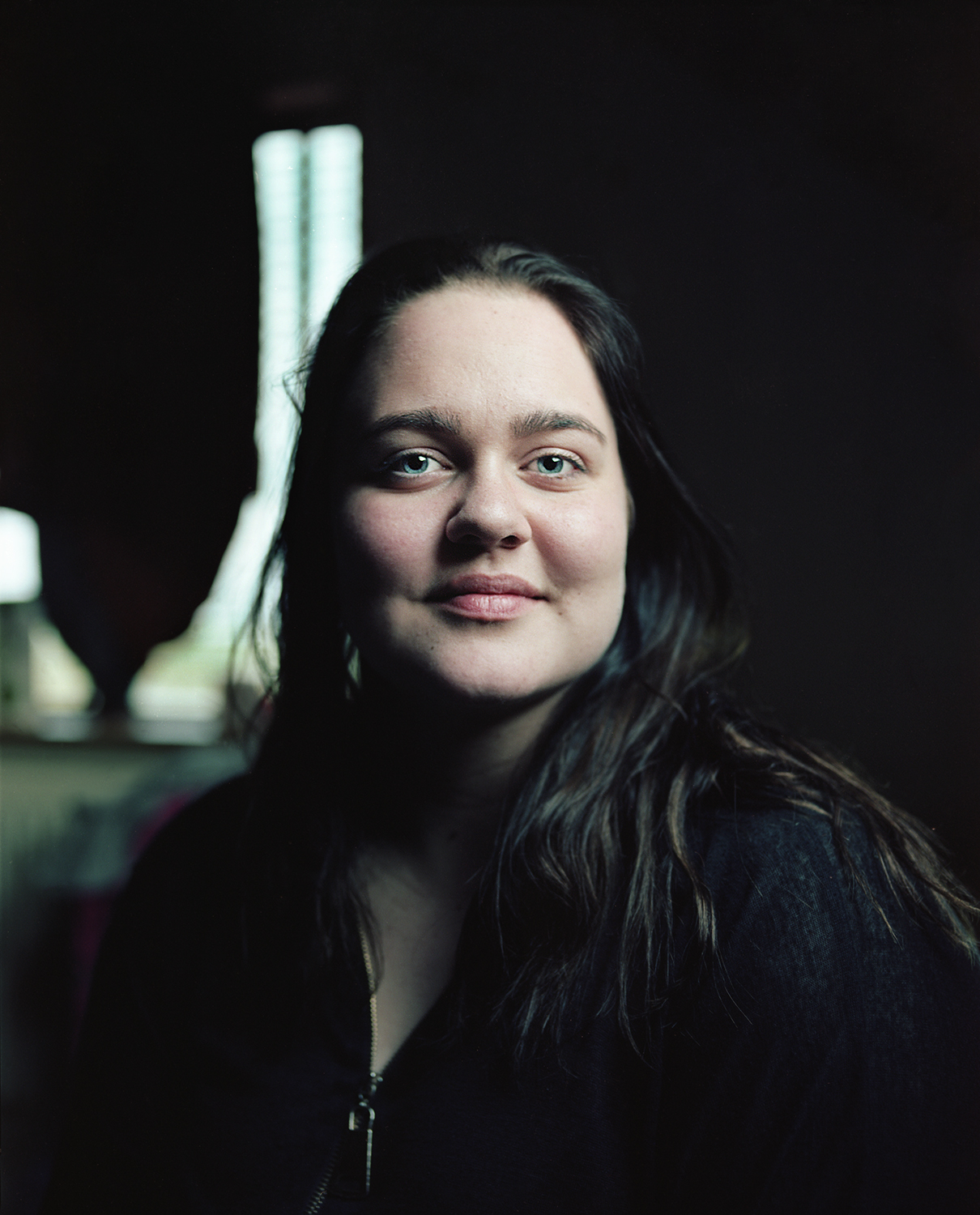 Heiða in her room at the staff lodging for Glacier Lagoon. She let me stay in her room when I was hitchhiking home. After this portrait she handed me a drink and took me outside to introduce me to the rest of the crew. Since they all live and work together they become more like a family. The majority of the crew returns every year to continue working at the Lagoon.