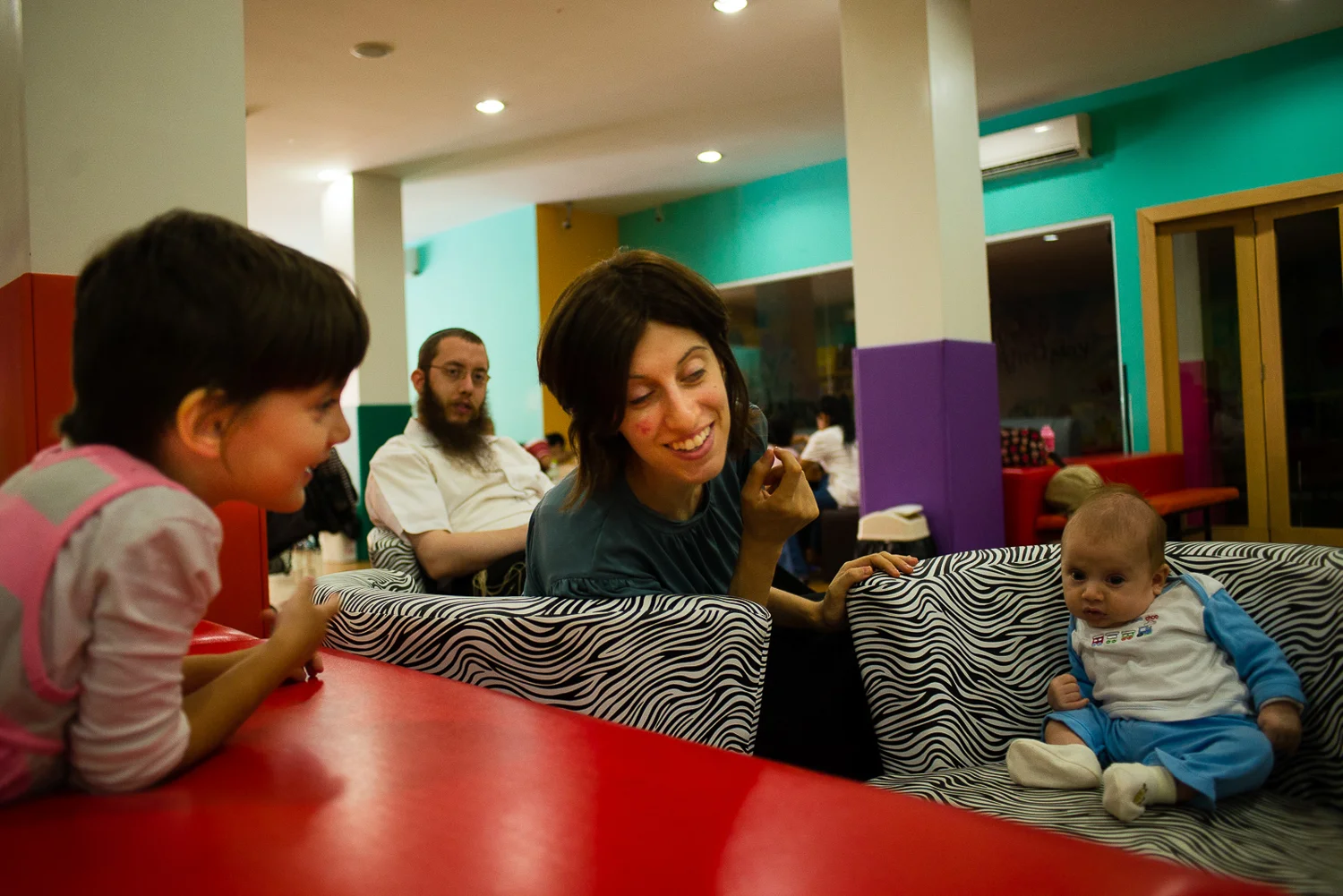 The Rabbi is often at the Jewish Center or attending other meetings around town. It is a rare occurance when the family gets to spend time all together, and they are grateful for it. Pictured here is Mushka, the Rabbi, Mashie, and their youngest son, Moshe.