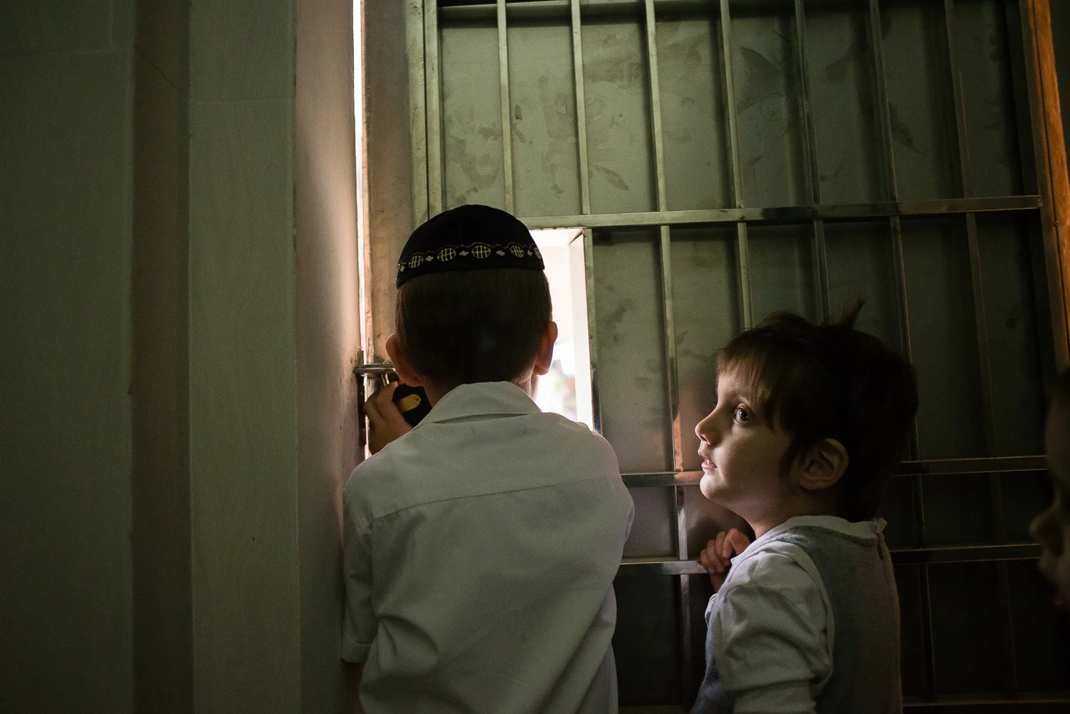 Zalman and Mushka look out onto the street as they wait for Mashie to go to Shul. 