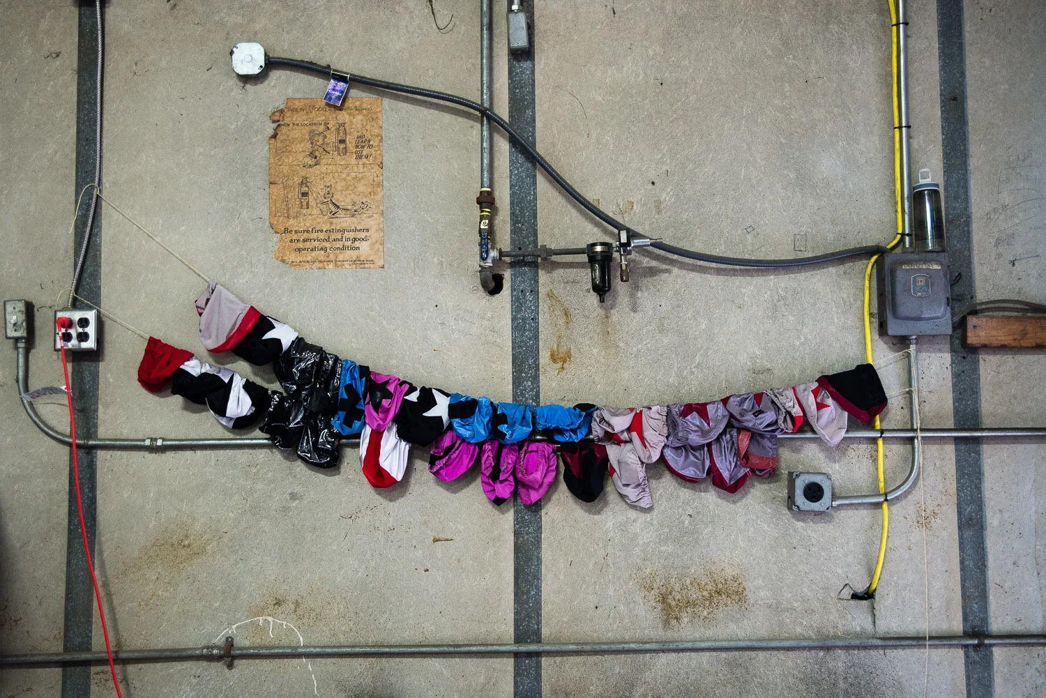 Positions on the roller derby court are made known by "panties", or helmet covers. These hang in CRG's practice space. 