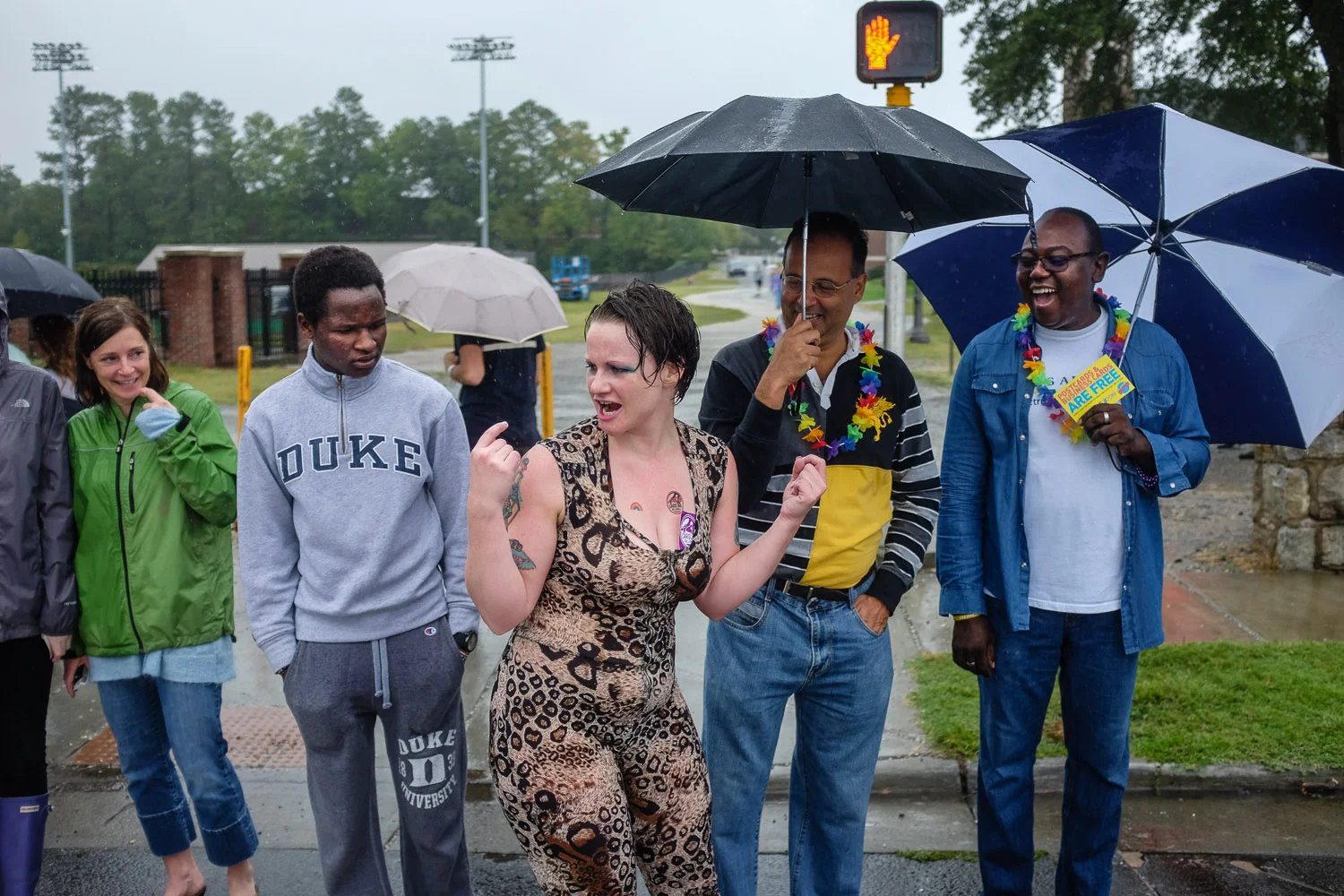 "Curve Appeal" hands out CRG stickers at the Durham Pride Parade. She has them sticking out of her one piece suit and is asking parade-goers to grab them out. 
