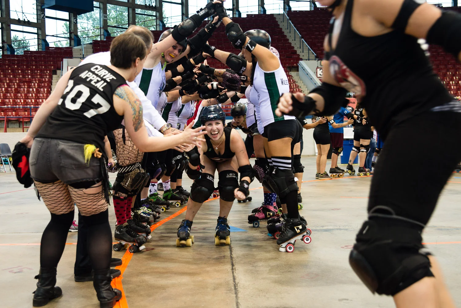 CRG players come through a pyramid made by the opposing team at the end of a game. 