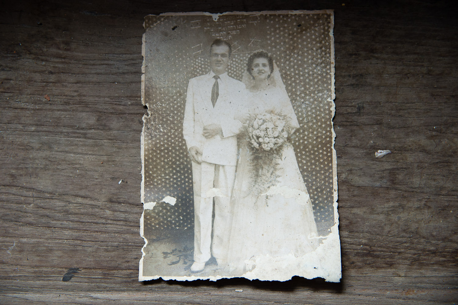 A wedding photograph lies on the windowsill of a Jewish home, vacated in the last decade as its owners died or left for Israel. The ground floor of the house now serves as the temporary Chabad house.