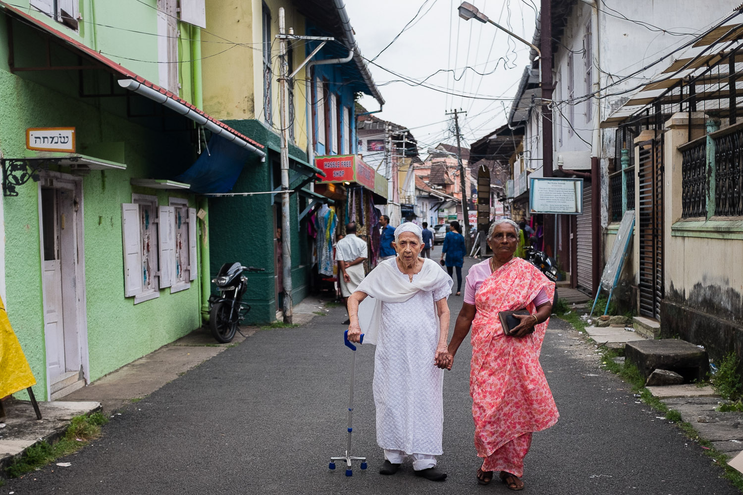 Queenie, one of the remaining Paradesi Jews, and her helper on their way to the Paradesi services for Kol Nidrei, the services on the eve of Yom Kippur, the holiest day of the Jewish calendar.