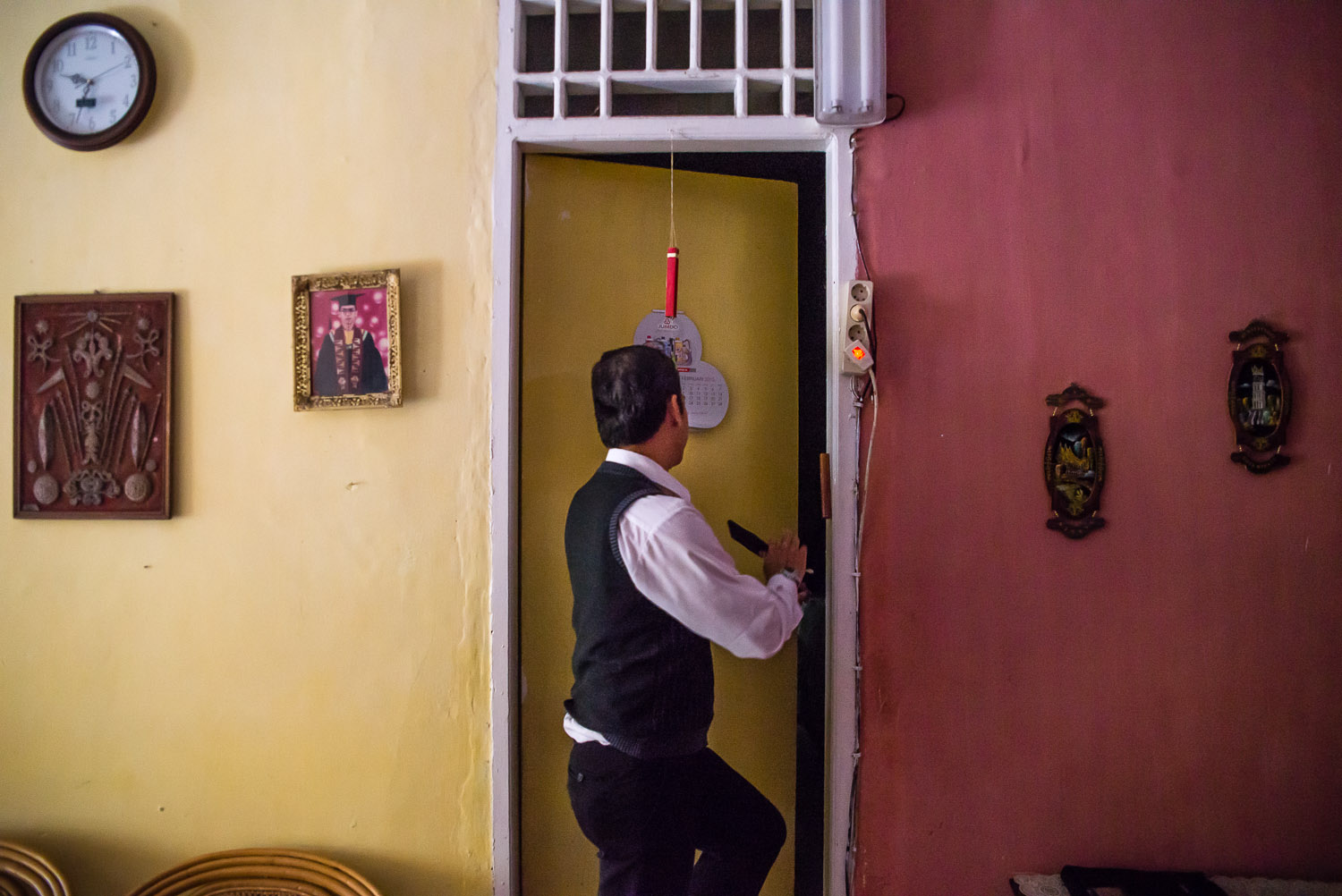  Benjamin Meijer Verbrugge (Benny), the leader of the United Indonesian Jewish Community, leads the way into his home synagogue in Lampung, Sumatra. "This door marks where Kosher begins. My house, it can't always be Kosher. But inside the synagogue 