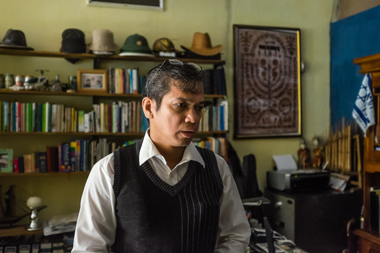   Benny in his home office, where he studies and also records videos to send out to other community members on other islands. Benny and his family live in Lampung, on Sumatra, where they are some of the only Jews. He is in frequent contact with the c