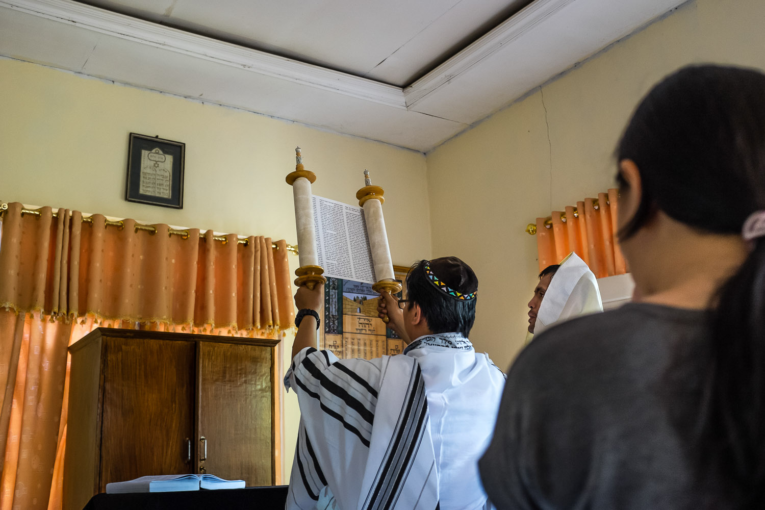   Vicktor (Noakh) holds the Torah during Saturday morning services in Manado.  