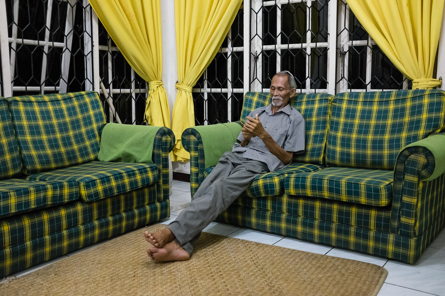   Vicky's father, Ferdinand (Benayahu) rests and checks his phone after Shabbat dinner. While most of the Jewish community is quite observant, they do not feel it is important to follow all the Jewish laws in a strictly Orthodox sense, and so the who