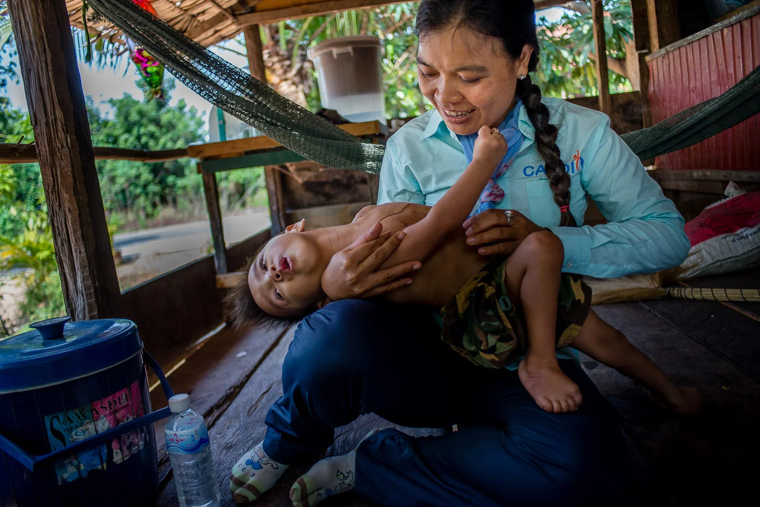Phearom, a Child Rehabilitation Officer with Cabdico, visits with a regular patient, Lihour Srean (3) whom she has been working with for one year. Lihour has severe cerebral palsy. 