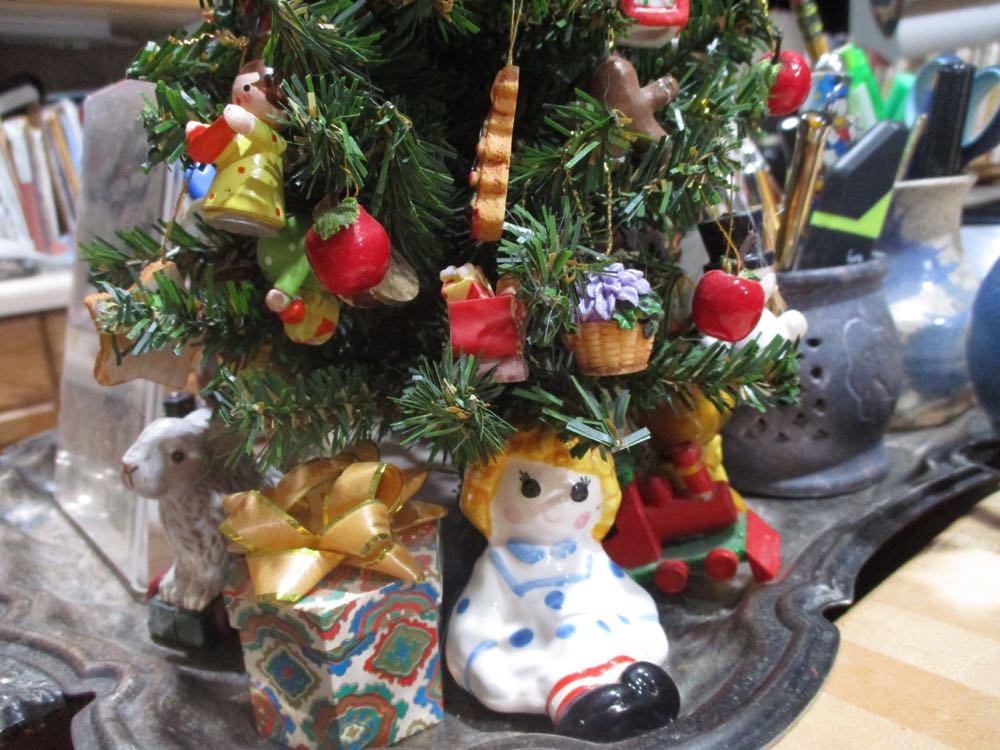 The artificial Christmas tree that stays out all year around, this time of year in my kitchen, surrounded by vintage salt shakers in the shape of dolls, teddy bears and trains.
