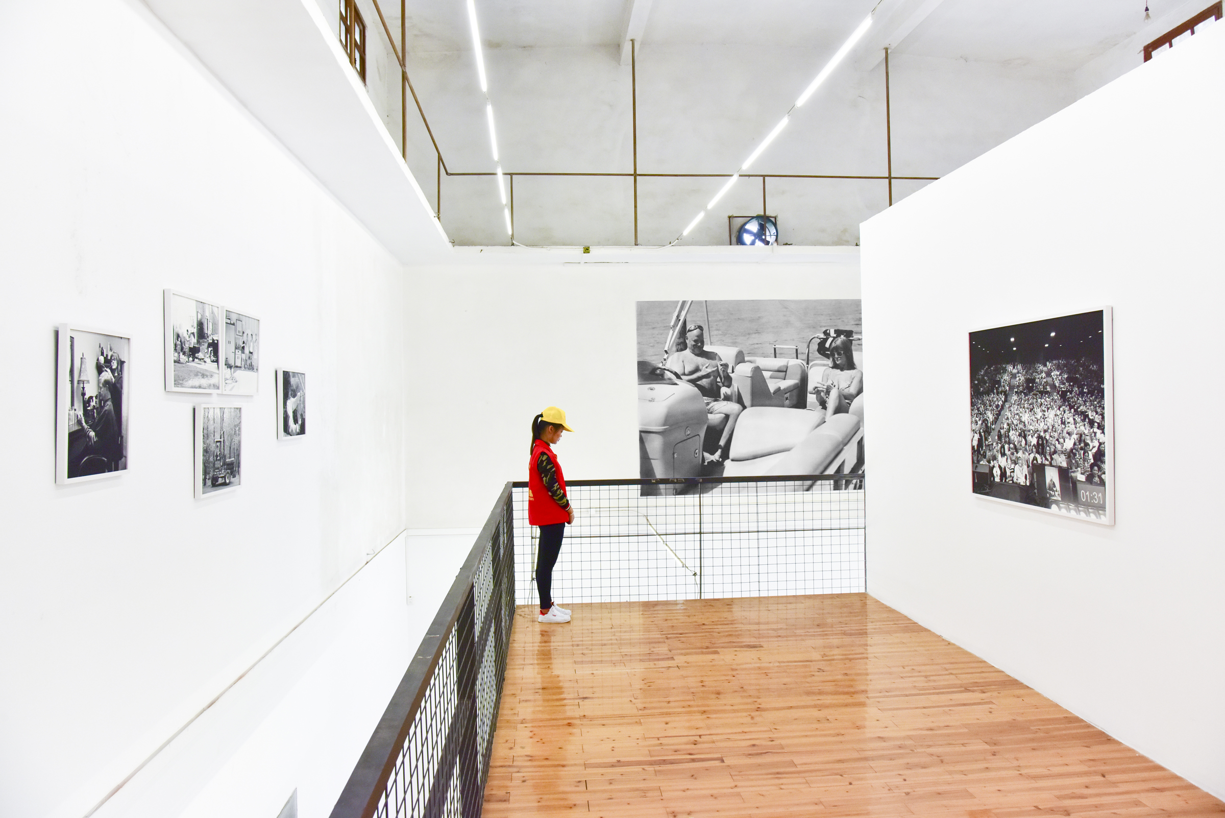  Installation photographs of Removed series by Eric Pickersgill at Lianzhou Foto Festival in Lianzhou, China 2016. Removed is a series of large format black and white photographs that are of individuals performing as if they are using thier devices a