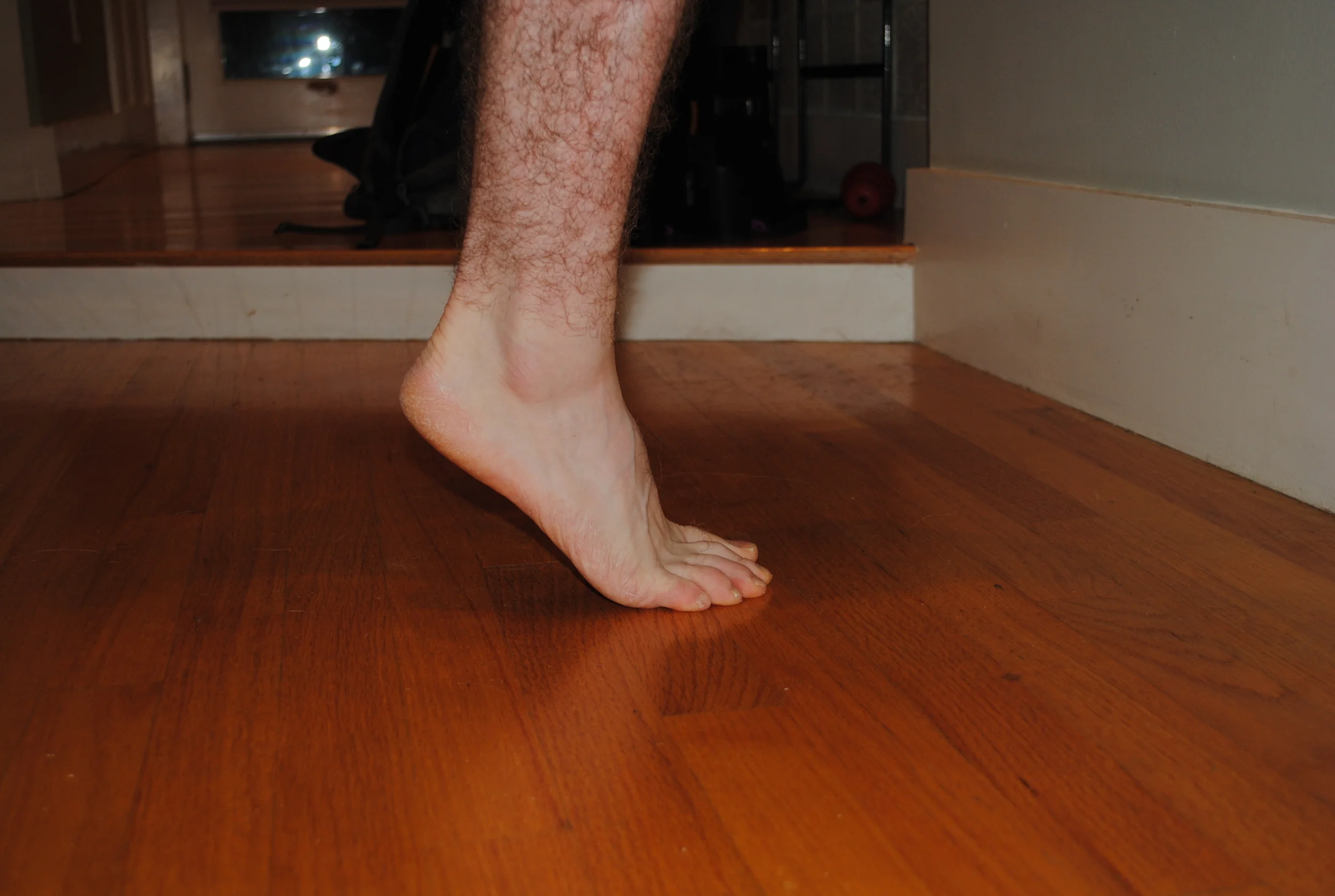 Press up on your toes as high as you can and then slowly lower your body weight back down. 