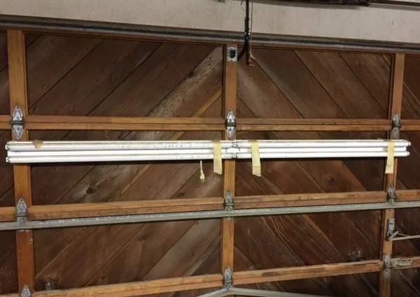 8' fluorescent light mounted to wood garage door