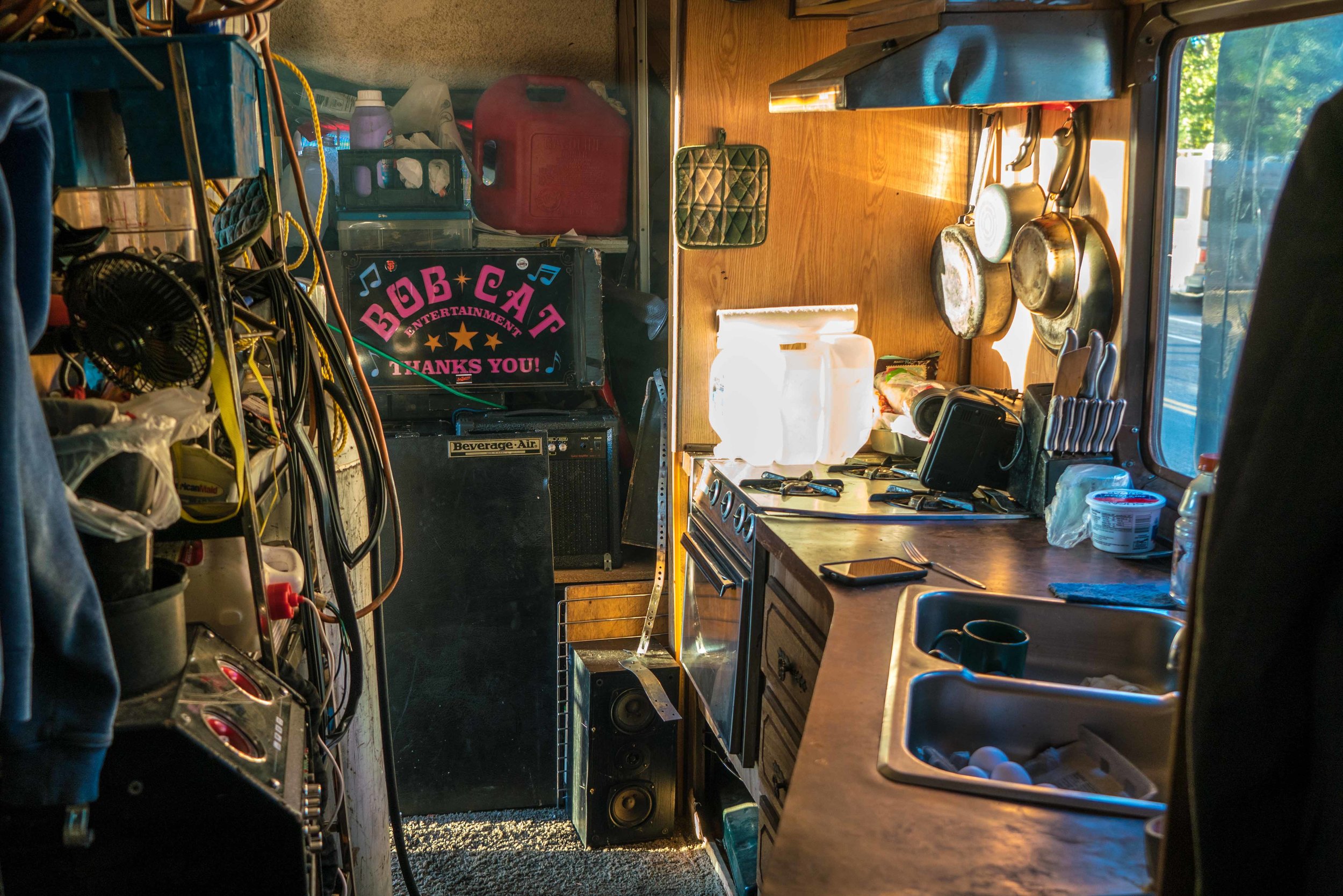 B. used his experience at the Tesla factory to learn about batteries and is now helping people experiencing homelessness fix battery-powered items, including cell phones and stereos. He even uses batteries to power guitar amps for himself and other street musicians.