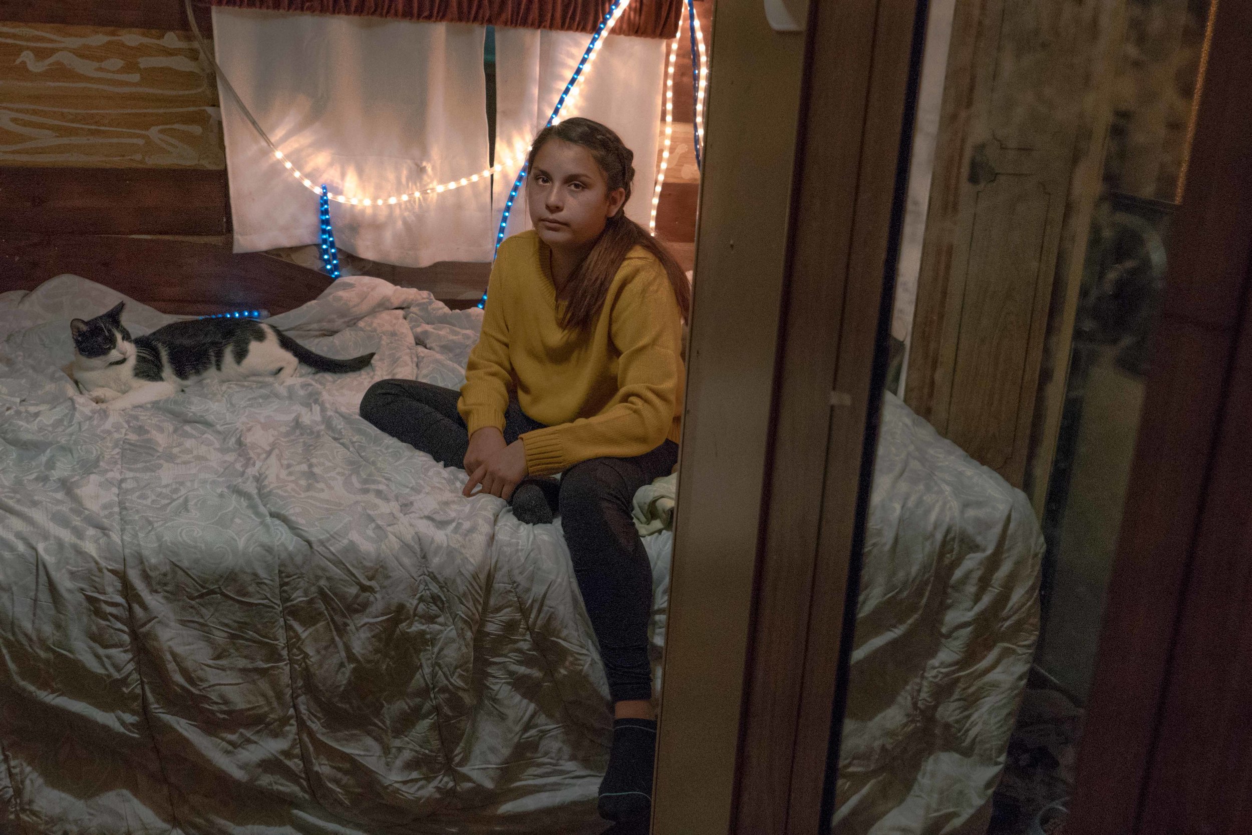 This young woman lives with her father, Dave Ramsey, in a camper in the Reno-Sparks Indian Colony church parking lot. Ramsey works as the night security guard for the church. After working for Tesla as a driver, he decided to go back to a job that didn’t move him around so much, so he could spend more time with his daughter.